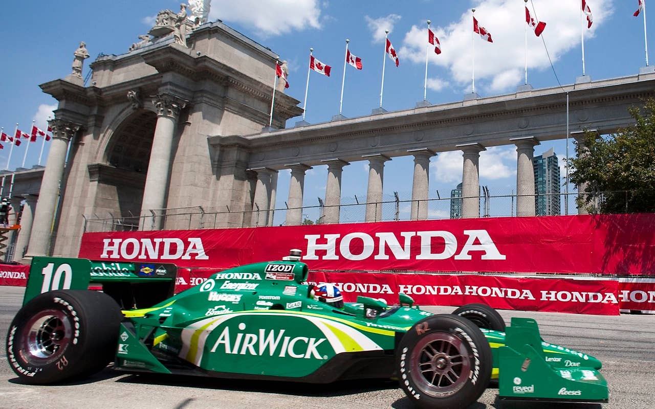 Dario Franchitti drives in front of Prince's Gate during the second practice session for the IndyCar Series' Honda Indy Toronto auto race in Toronto on Friday, July 16, 2010.