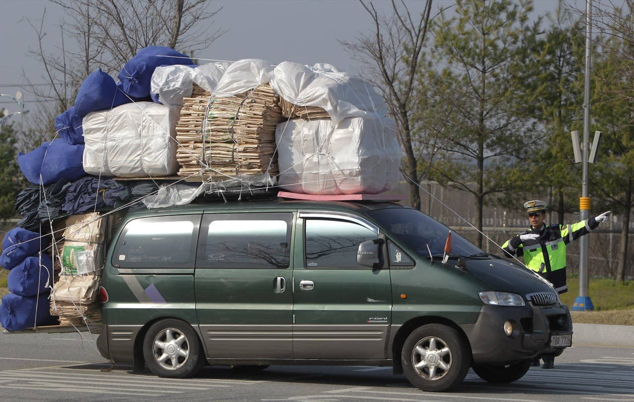 PAJU, SOUTH KOREA - APRIL 27: South Koren workers arriving from the Kaesong joint industrial complex in North Korea at the inter-Korean transit office on April 27, 2013 in Paju, South Korea. South Korean Unification Ministry annouced yesterday to withdraw all 170 remaining workers from Kaesong industrial complex after failing to persuade the North to restart the talk seeking the normalization of Kaesong's operation. (Photo by Chung Sung-Jun/Getty Images)
