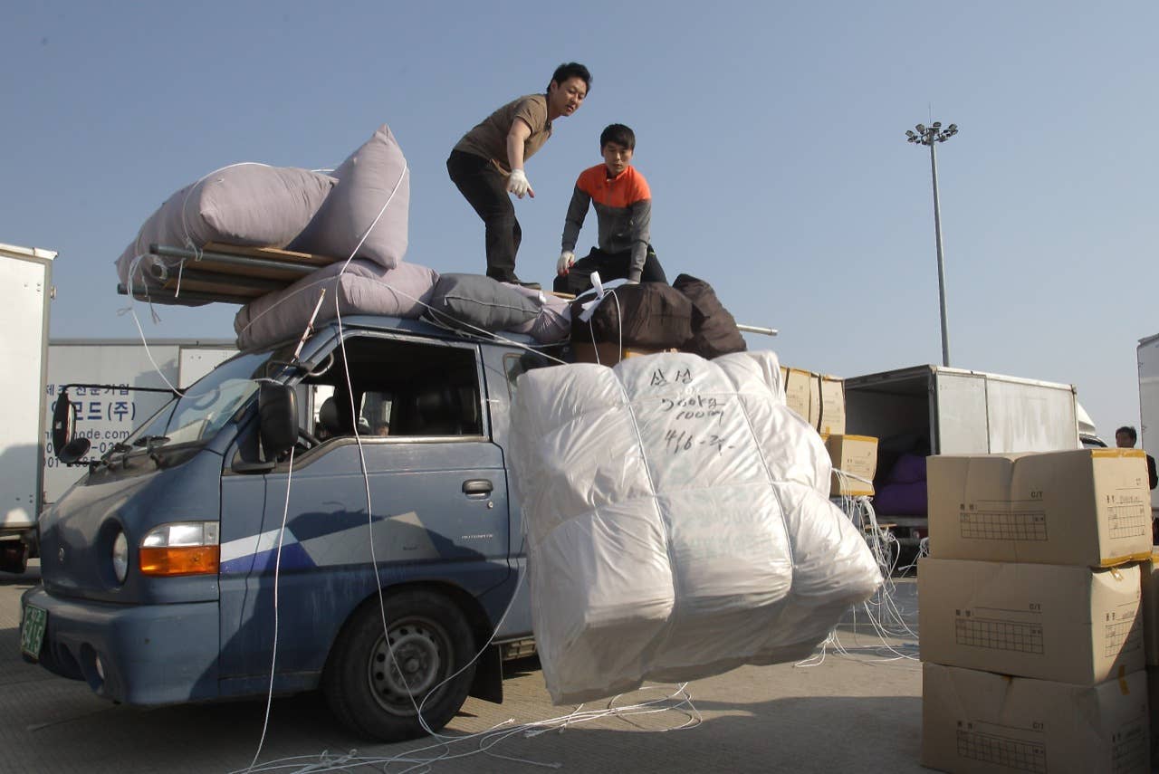 PAJU, SOUTH KOREA - APRIL 27:  South Korean workers unload their products made in North Korea's after arrive from the Kaesong joint industrial complex in North Korea at the inter-Korean transit office on April 27, 2013 in Paju, South Korea. South Korean Unification Ministry annouced yesterday to withdraw all 170 remaining workers from Kaesong industrial complex after failing to persuade the North to restart the talk seeking the normalization of Kaesong's operation.  (Photo by Chung Sung-Jun/Getty Images)