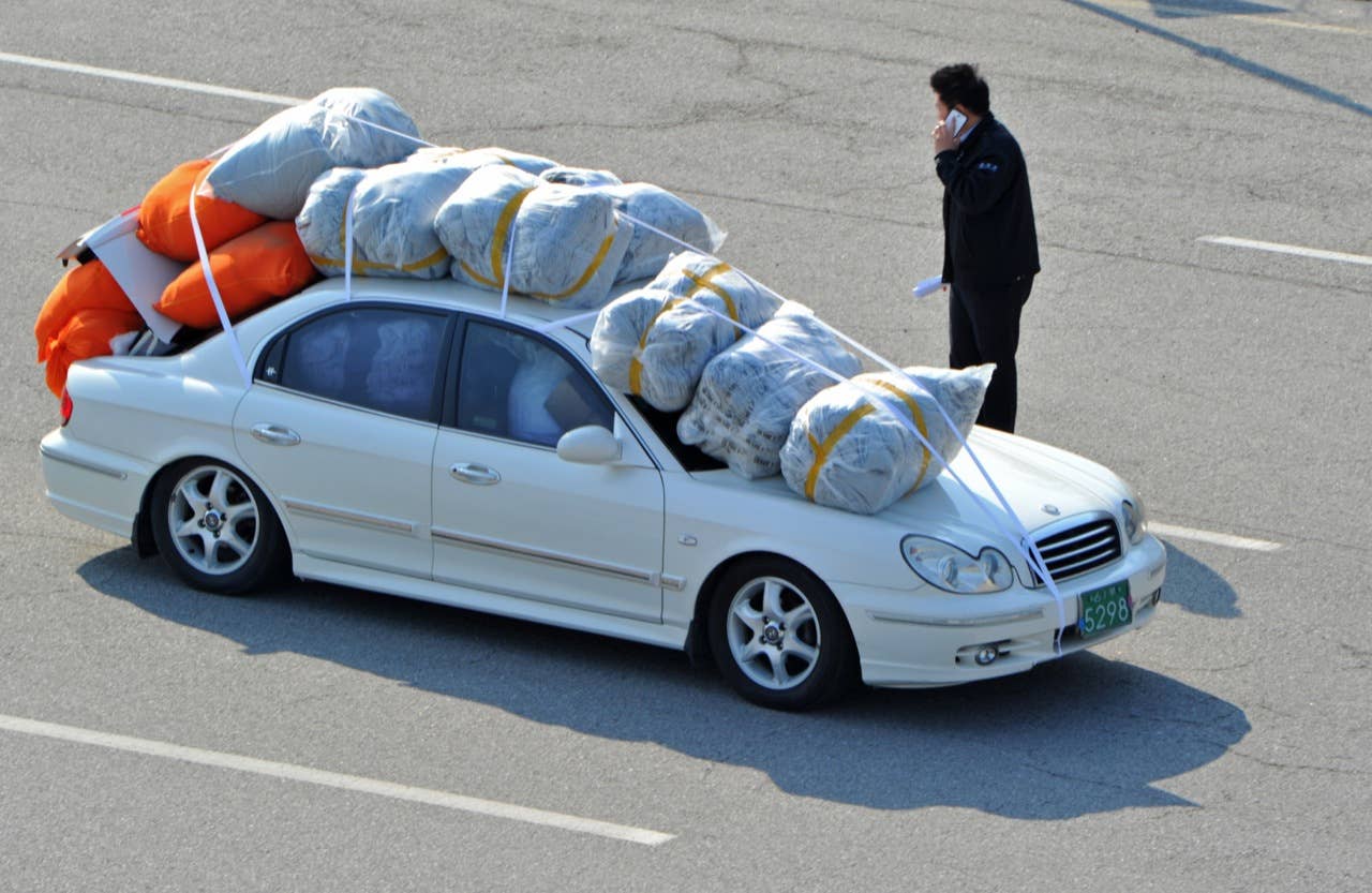 TOPSHOTS- A South Korean car carrying products made in inter-Korean Kaesong Industrial Complex in North Korea, arrives at a gate of the inter-Korean transit office in the border city of Paju on April 27, 2013. Dozens of South Korean workers returned from a jointly run factory park in North Korea on 27 April as part of an evacuation of the flagship project following months of military tensions. AFP PHOTO / KIM JAE-HWANKIM JAE-HWAN/AFP/Getty Images