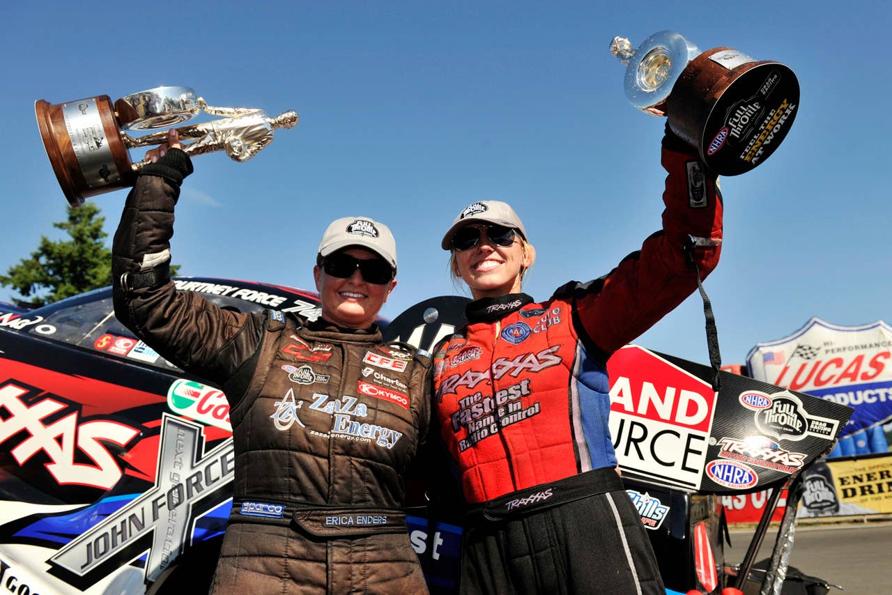 In this photo provided by NHRA, Courtney Force and Erica Enders celebrate their victories at the O'Reilly Auto Parts NHRA Northwest Nationals auto race at Pacific Raceways, Sunday, Aug. 5, 2012, in Kent, Wash. (AP Photo/NHRA, Theresa Long)