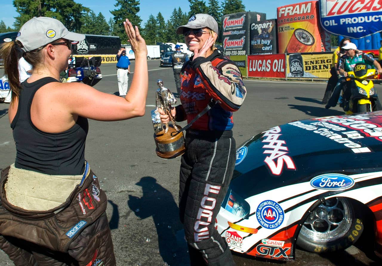 Driver Erica Enders, left, congratulates Courtney Force after they both won their events at the NHRA Northwest National at Pacific Raceway in Auburn, Wash., Sunday Aug. 5, 2012. This is the first time two women have won on the same day in a NHRA Professional category.  (AP Photo/Joe Barrentine/The News Tribune)