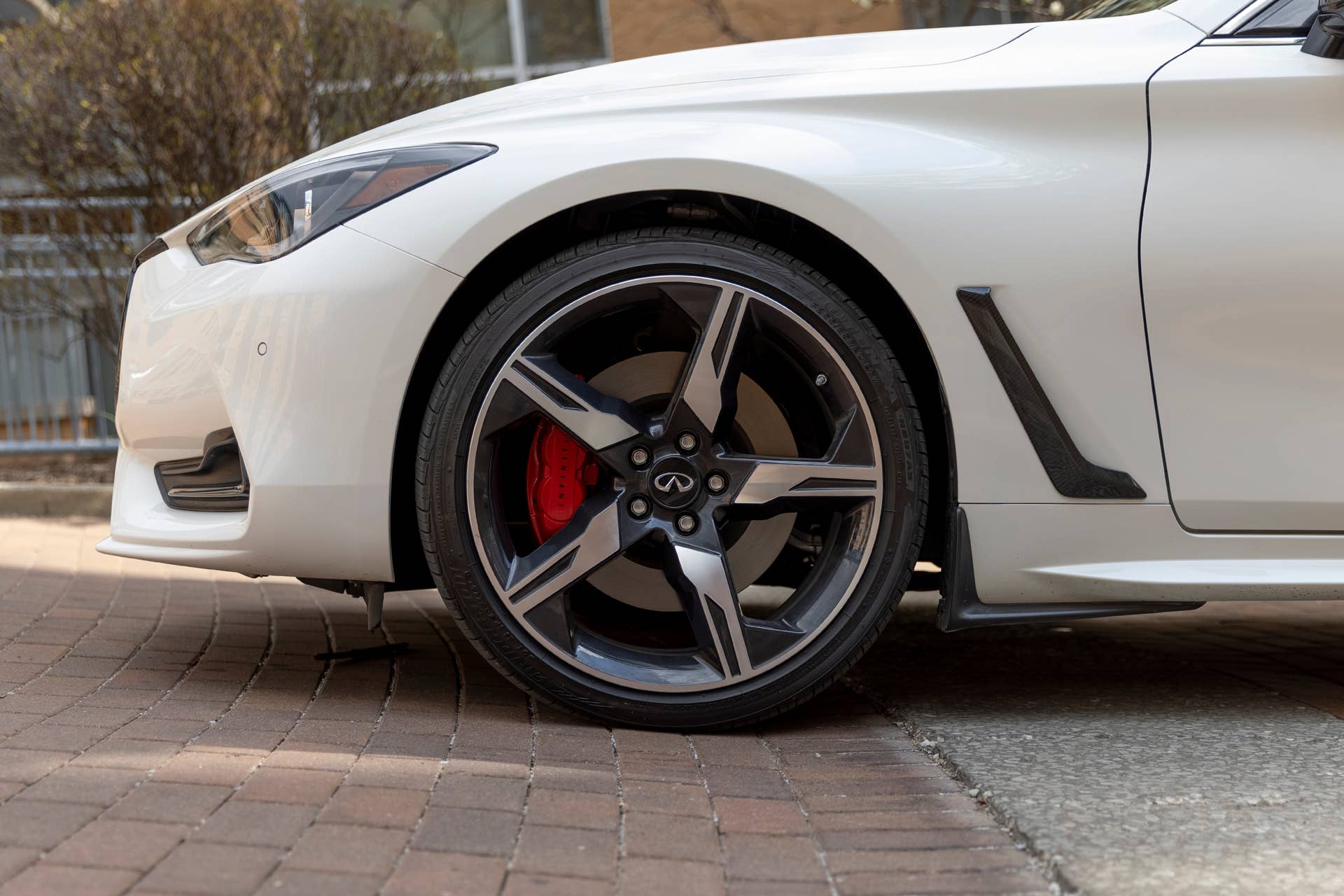 Q60 RED SPORT 400 AWD shown in Majestic White featuring 20-inch accessory alloy wheels