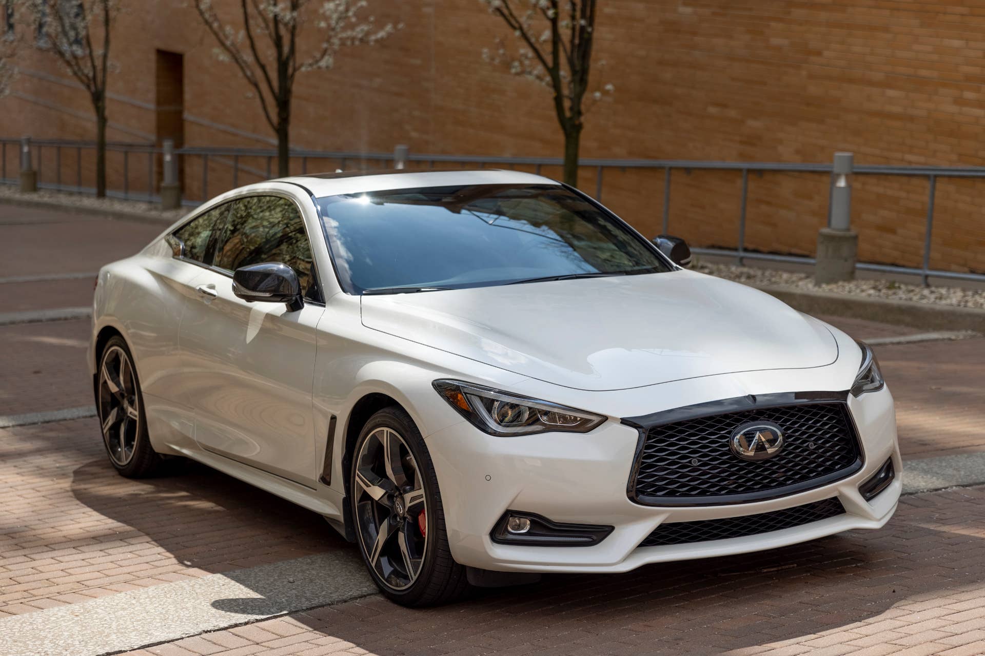 Q60 RED SPORT 400 AWD shown in Majestic White featuring 20-inch accessory alloy wheels