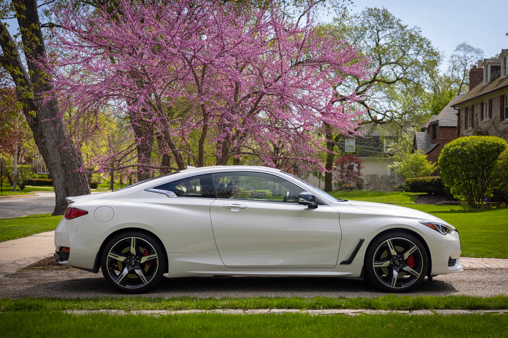 Q60 RED SPORT 400 AWD shown in Majestic White featuring 20-inch accessory alloy wheels