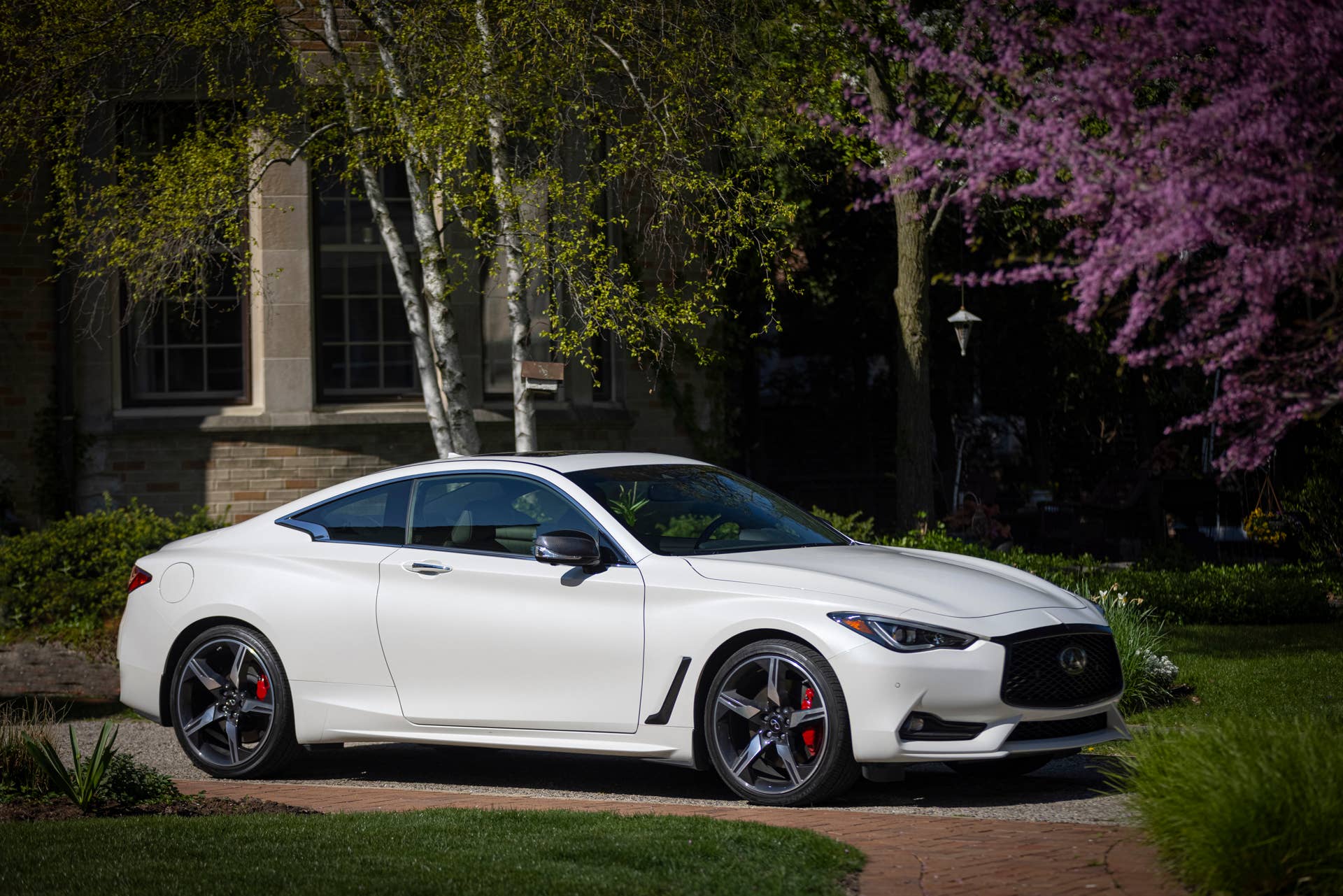 Q60 RED SPORT 400 AWD shown in Majestic White featuring 20-inch accessory alloy wheels