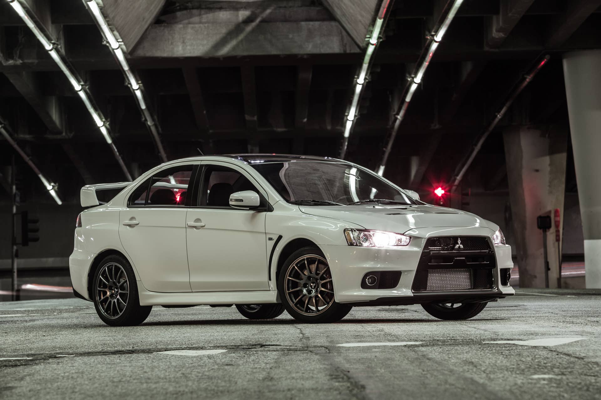 The 2015 Mitsubishi Lancer Evolution Final Edition, nighttime shot, front three-quarter.