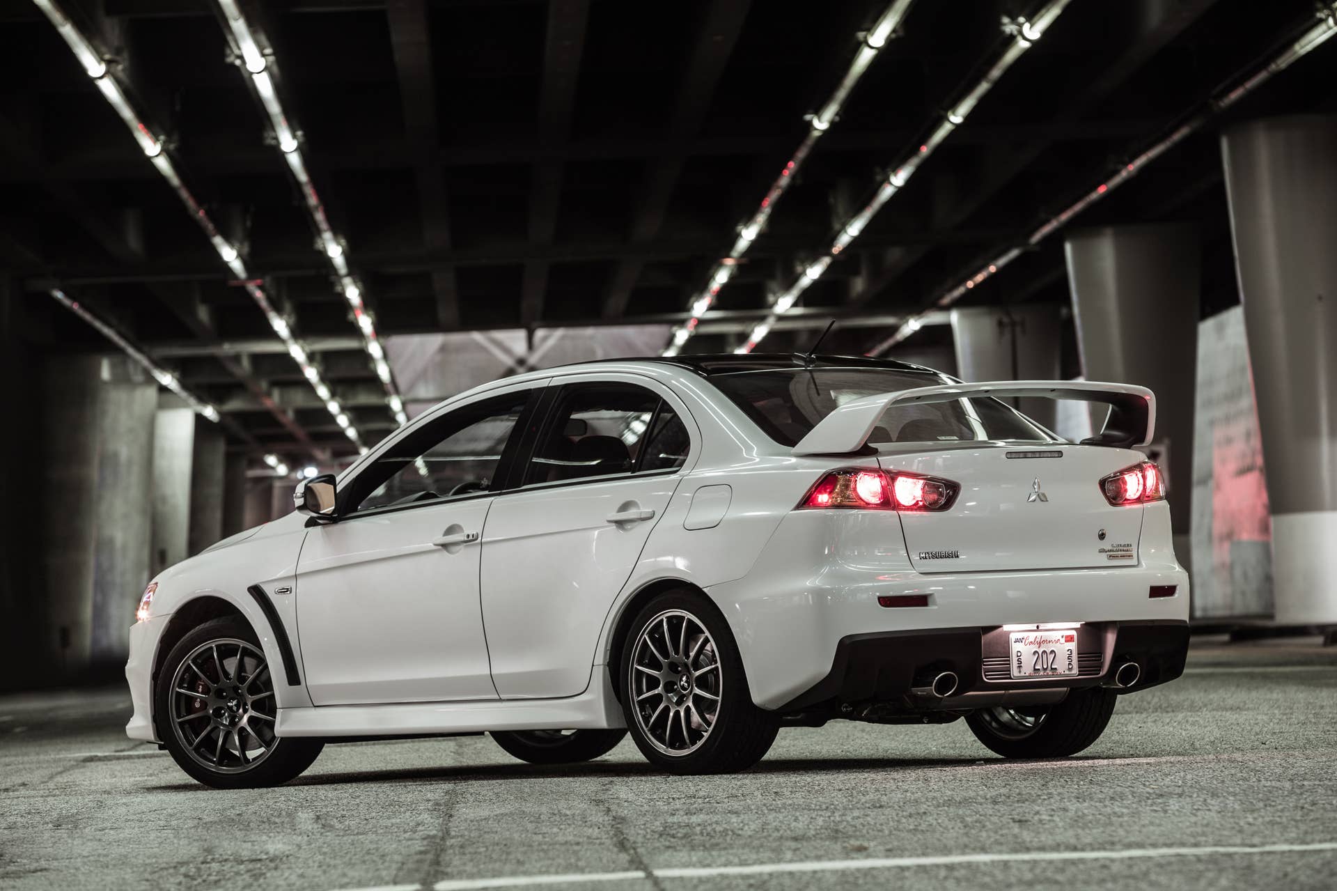 The 2015 Mitsubishi Lancer Evolution Final Edition, nighttime shot, rear three-quarter.