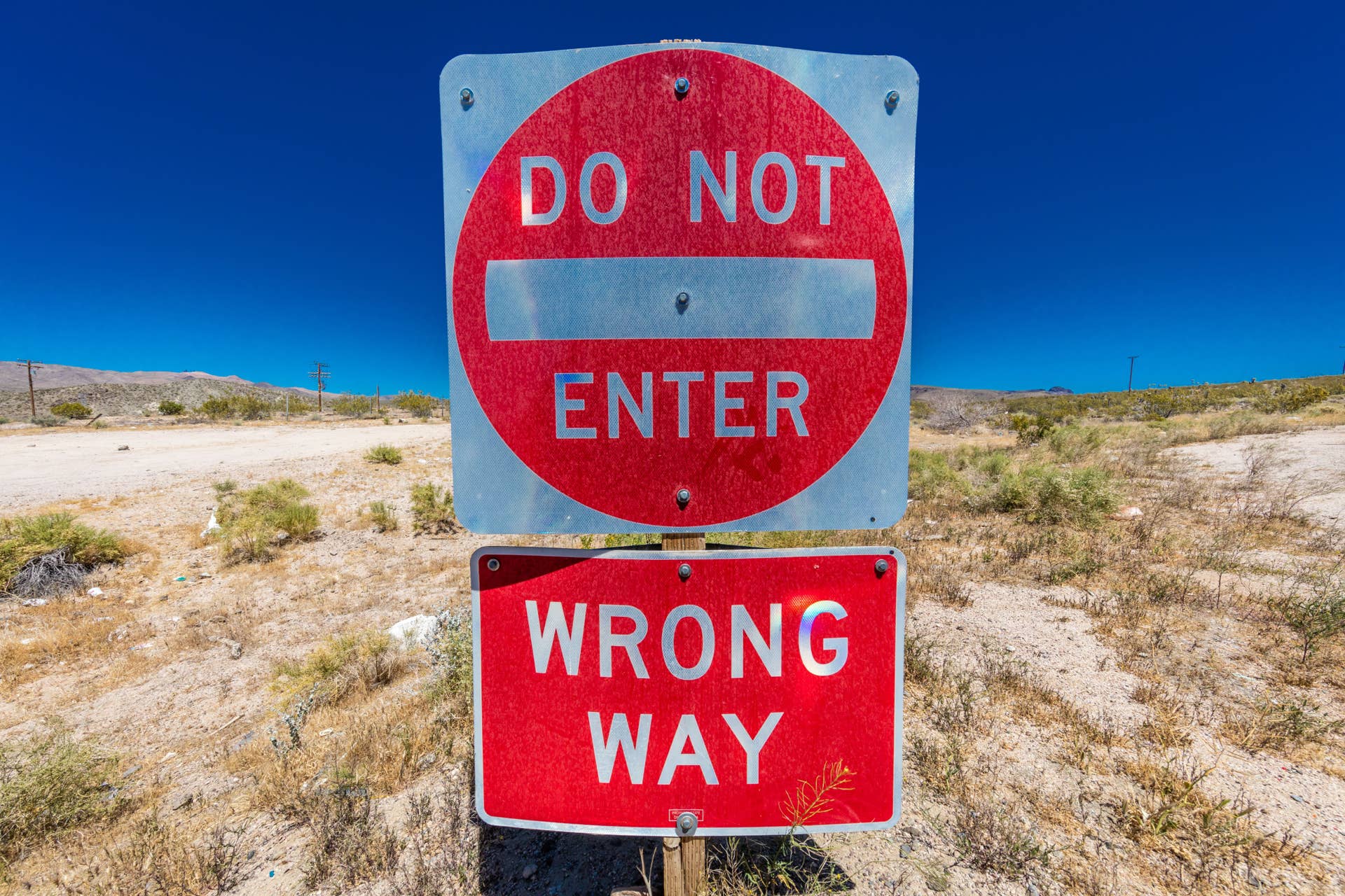Bright Red sign warns drivers not to enter this lane of highway, Interstate 15, in desert outside of Las Vegas - WARNING - WRONG WAY!, Nevada. (Photo by: Joe Sohm/Visions of America/Universal Images Group via Getty Images)