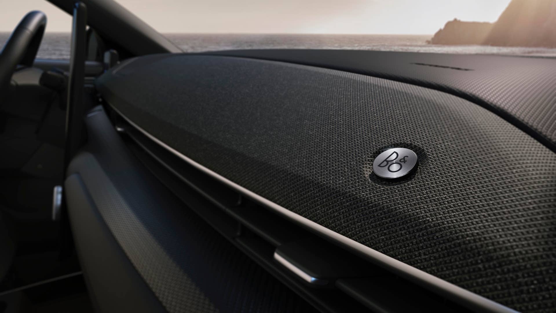 A premium cloth-covered soundbar runs across the front of the Mustang Mach-E, seamlessly integrating B&O Sound System by BANG & OLUFSEN© speakers. BANG & OLUFSEN© 2019 and B&O© 2019. BANG & OLUFSEN™ and B&O™ are registered trademarks of Bang & Olufsen Group. Licensed by Harman Becker Automotive Systems Manufacturing Kft. All rights reserved.