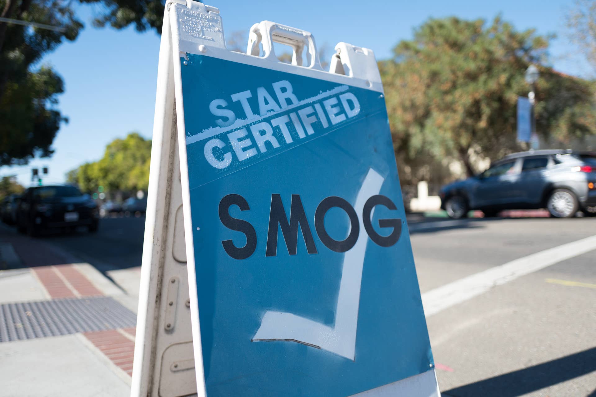 Low-angle view of sign for a California emissions inspection station, colloquially known as a Smog Station, which ensures that motor vehicles comply with California's stringent emissions requirements, in downtown Livermore, California, October 16, 2018. (Photo by Smith Collection/Gado/Getty Images)