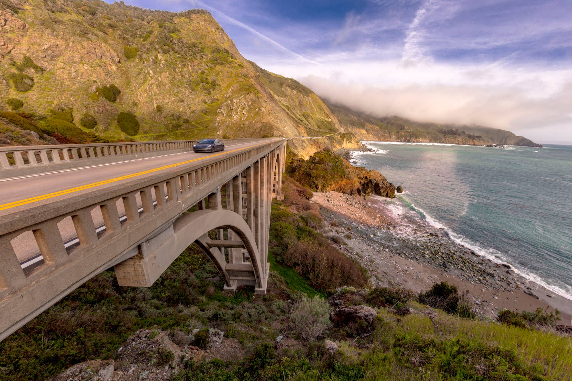 Bixby bridge on Route 1, Pacific Coast Highway, PCH, with spring flowers lining road, California. (Photo by: Visions of America/Education Images/Universal Images Group via Getty Images)