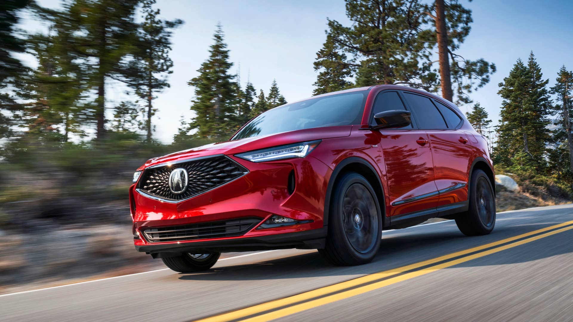 2022 MDX SH-AWD A-Spec Performance Red Pearl 3/4 Front Passenger Exterior running back road