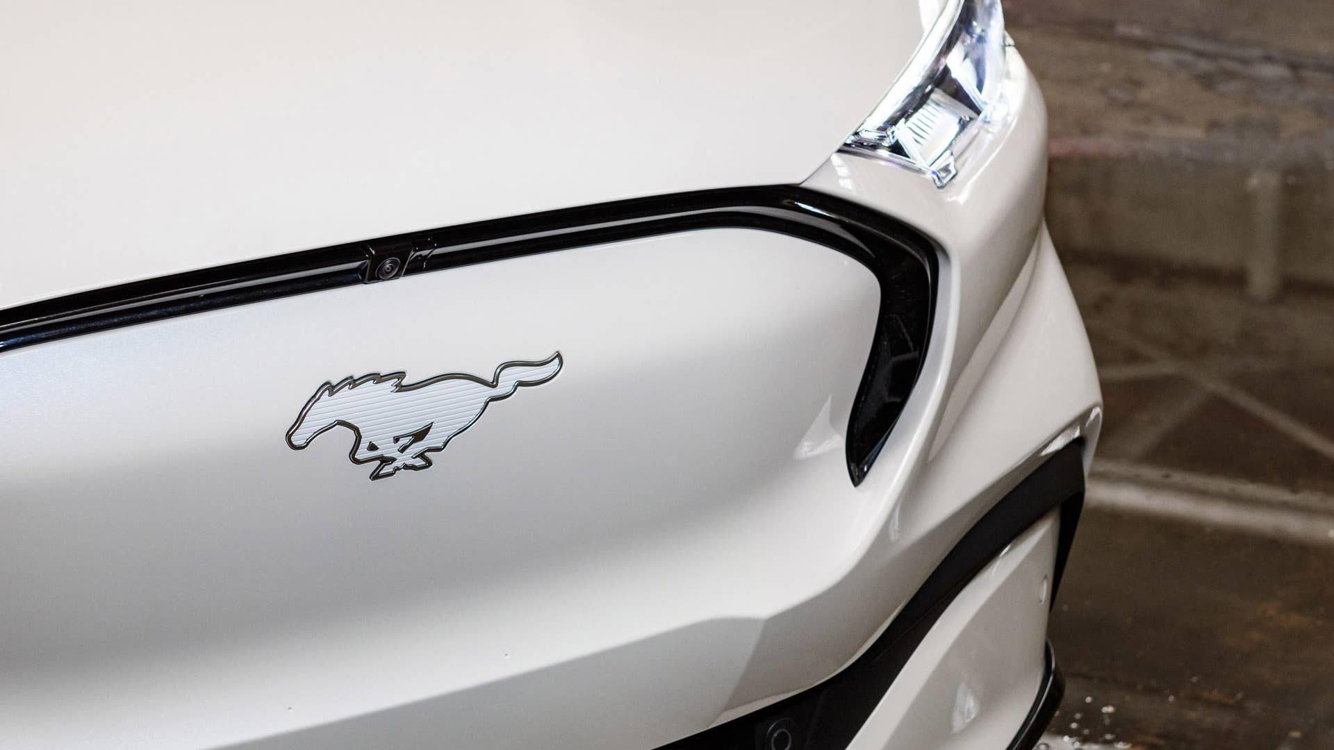 Available Ice White Appearance Package on appropriately configured 2022 Mustang Mach-E and Mustang Coupe models. Closed course.