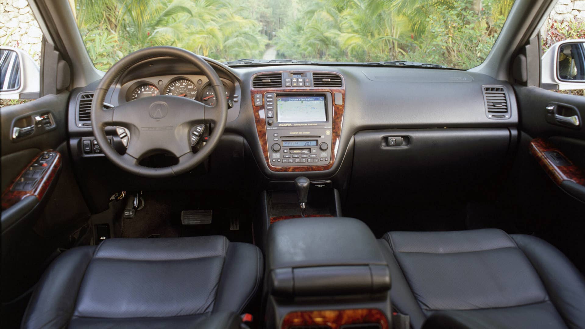 The interior of the MDX hosts a long list of standard features, and is uniquely transformable, capable of accommodating up to seven passengers.  Second- and third-row seats that split and fold flat into the floor make for an interior that can be quickly and easy reconfigured to accommodate from one to seven passengers and a wide variety of cargo, from gardening to recreation and sports equipment, including a six foot ladder.  A wide track and flat floor design further enhance the vehicle’s passenger and cargo carrying capabilities. The optional Acura Navigation System with DVD (digital versatile disc) contains mapping of the continental U.S. on a single disc and features a nationwide directory of 3.7-million points of interest, restaurants, hotels, ATMs and a number of other categories.  In addition, the system offers a unique line trace function that leaves “electronic bread crumbs” on the navigation screen for re-tracing your steps during off-road excursions in unmapped areas.