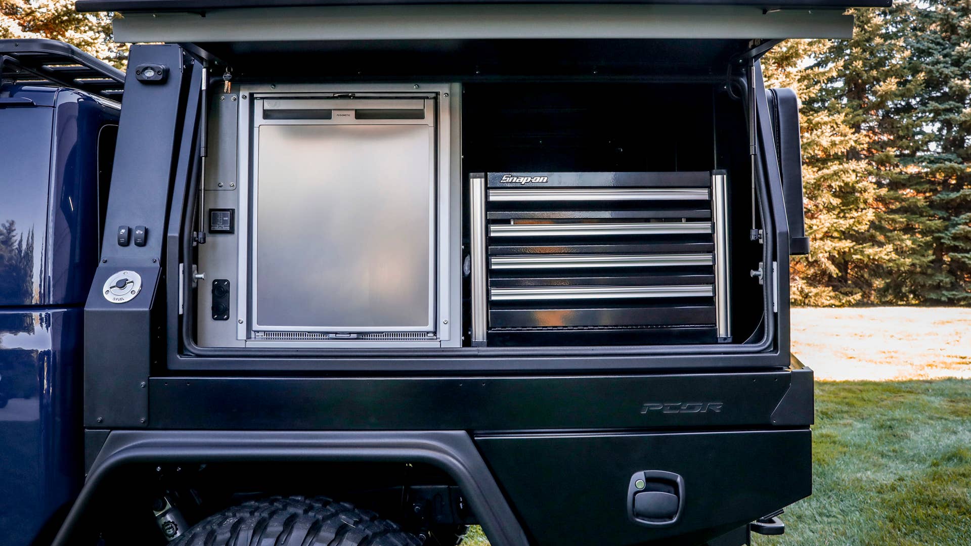 On the driver’s-side of the PCOR storage system of the Jeep Top Dog Concept, a battery-powered refrigerator and electric hot-dog roller grill stand ready to refuel riders for the next section of challenging trails.