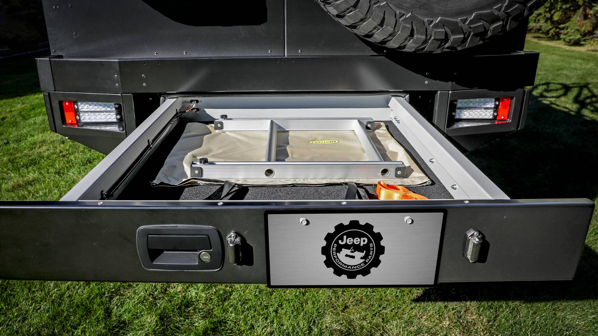 At the rear of the Jeep Gladiator Top Dog Concept is a roll-out storage drawer that carries a foldable ladder used for access to the dual bike rack.