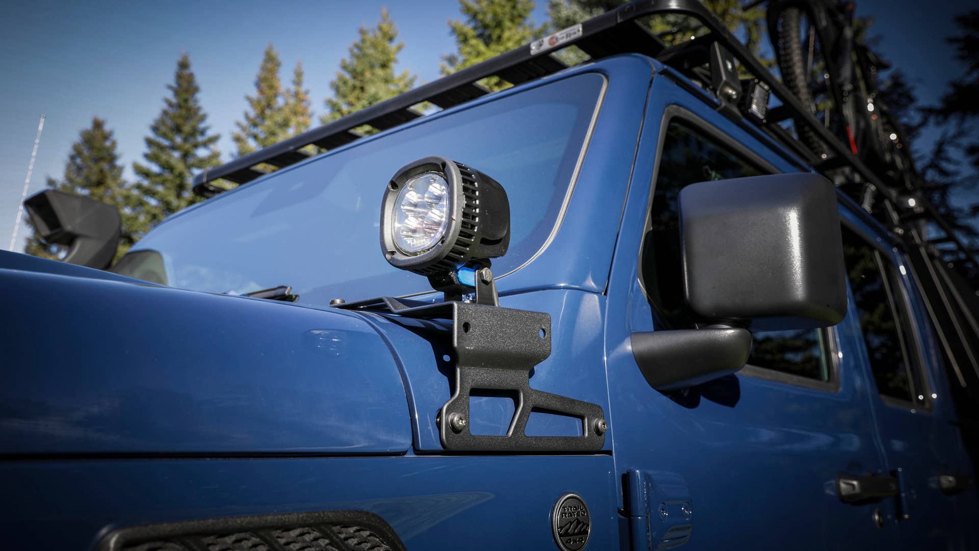 A pair of JPP five-inch off-road LED lights are installed at the base of the A-pillars of the Jeep Gladiator Top Dog Concept to help illuminate the trail.