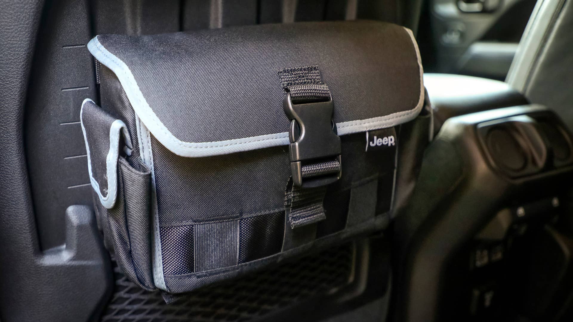 Inside the cabin of the Jeep Gladiator Top Dog concept, MOLLE (Modular Lightweight Load-carrying Equipment) bags provide extra storage and conveniently attach to the rear of the front seats.