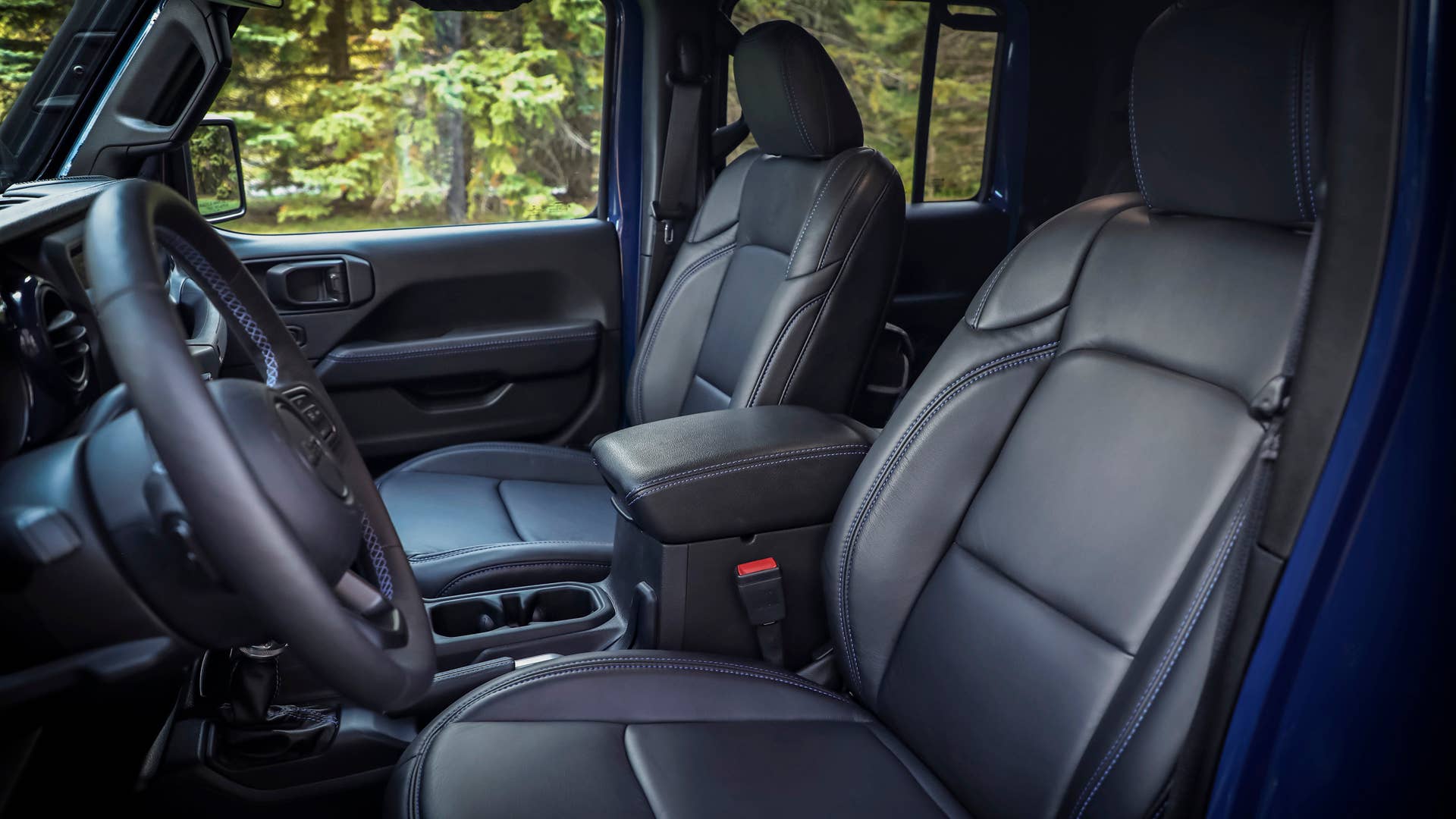 Inside the cabin of the Jeep Gladiator Top Dog Concept are black Katzkin leather seats, armrests and steering wheel accented with blue stitching.