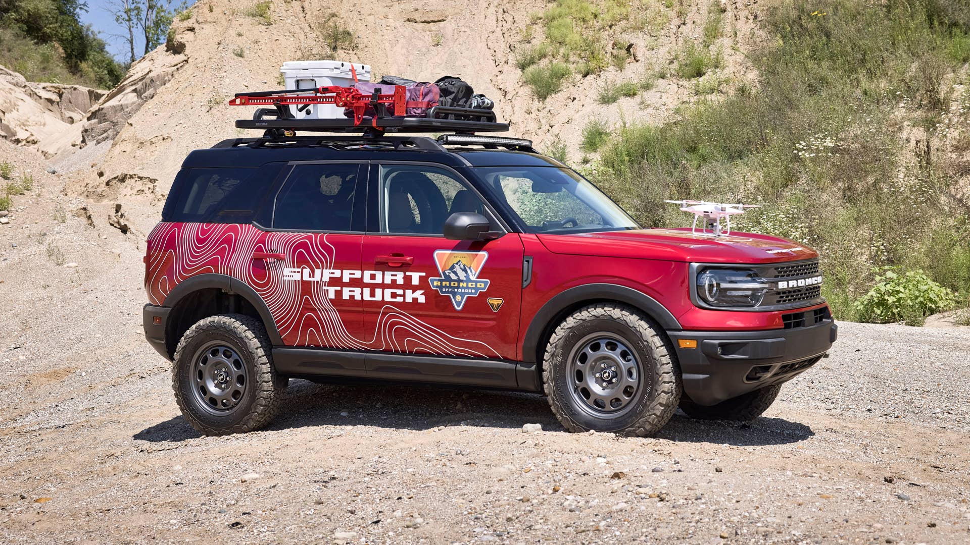 Bronco Sport Off-Roadeo Adventure Patrol. Designed for the upcoming Bronco Off-Roadeo customer adventure playgrounds, this Bronco Sport Badlands build is equipped to assist in the wild with its Yakima LockNLoad Cargo Platform to hold recovery gear like a high-lift jack, recovery boards and jerry cans. A Ford Performance by RIGID off-road LED lightbar* also mounts to the rack system. To support one of many Off-Roadeo excursions available, this Bronco Sport is equipped with the interior bike rack* from Yakima to hold two mountain bikes. And to record customers’ adventures, it integrates a target to land the drone that will be used on-trail at Off-Roadeo locations. (Preproduction image with optional features shown. Available late 2020.)(*available spring 2021)