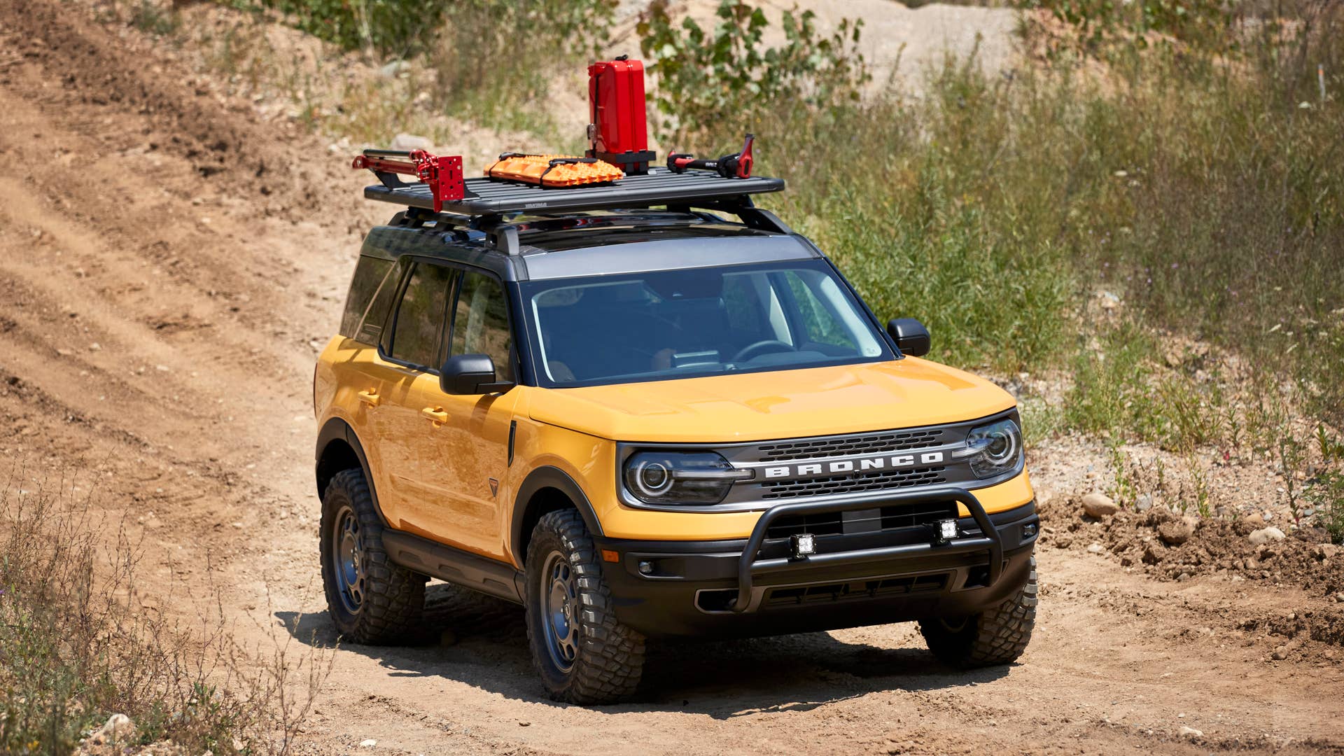 Bronco Sport Trail Rig. For adventurers looking to elevate their off-road trekking in a small, rugged 4x4, the Bronco Sport Trail Rig amps up the Badlands series model by adding 31-inch BFGoodrich™ Mud-Terrain T/A® KM3 tires, a one-inch lift kit, plus Ford Performance by RIGID LED off-road lights mounted to a front nudge bar. On top, a Yakima LockNLoad Platform roof rack and off-road gear mounts are designed to carry gear like a high-lift jack kit, Ford Performance recovery boards and jerry cans. (Preproduction image with optional features shown. Available late 2020.)