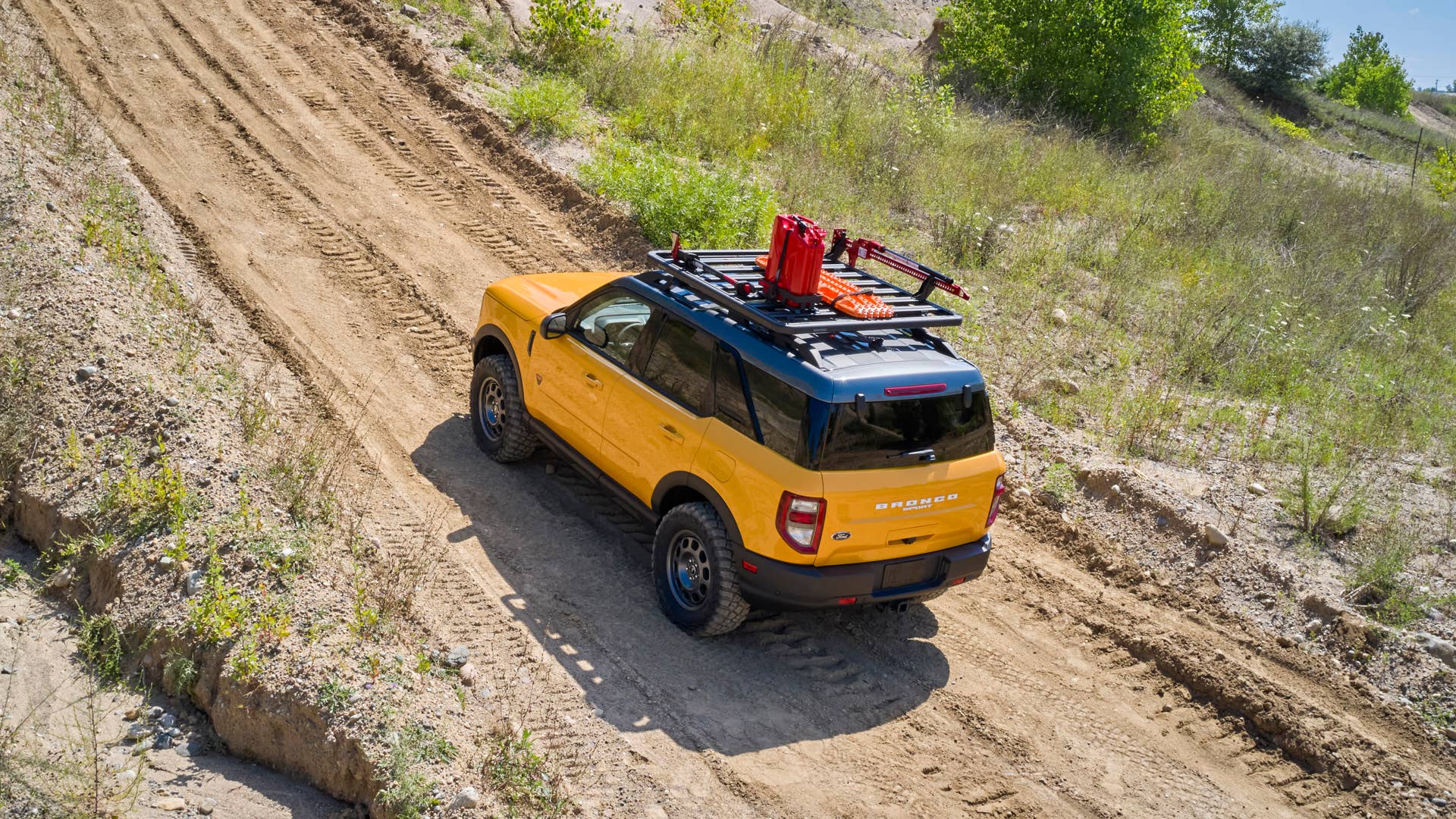 Bronco Sport Trail Rig. For adventurers looking to elevate their off-road trekking in a small, rugged 4x4, the Bronco Sport Trail Rig amps up the Badlands series model by adding 31-inch BFGoodrich™ Mud-Terrain T/A® KM3 tires, a one-inch lift kit, plus Ford Performance by RIGID LED off-road lights mounted to a front nudge bar. On top, a Yakima LockNLoad Platform roof rack and off-road gear mounts are designed to carry gear like a high-lift jack kit, Ford Performance recovery boards and jerry cans. (Preproduction image with optional features shown. Available late 2020.)