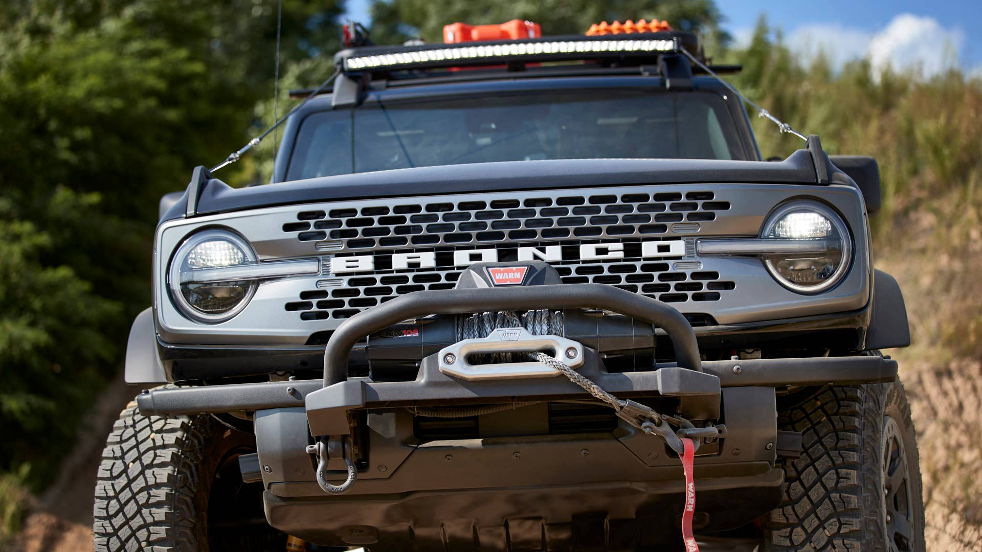 Bronco Two-Door Trail Rig. Designed to be the ultimate hardcore trail rider, this custom build is based on the two-door Badlands™ series. It begins with a Ford Performance modular front bumper, tube doors, beadlock-capable wheels  and 40-inch RIGID® LED lightbar. A Ford Performance by WARN® winch helps rescue your lesser-equipped 4x4 friends. On top, factory roof rails are augmented with a Yakima Platform roof rack system with mounts for a shovel, and Ford Performance by WARN recovery kit and recovery boards. Inside are rugged floor mats and a rear swing-gate-mounted table. (Preproduction image with optional features shown. Available beginning Spring 2021.)