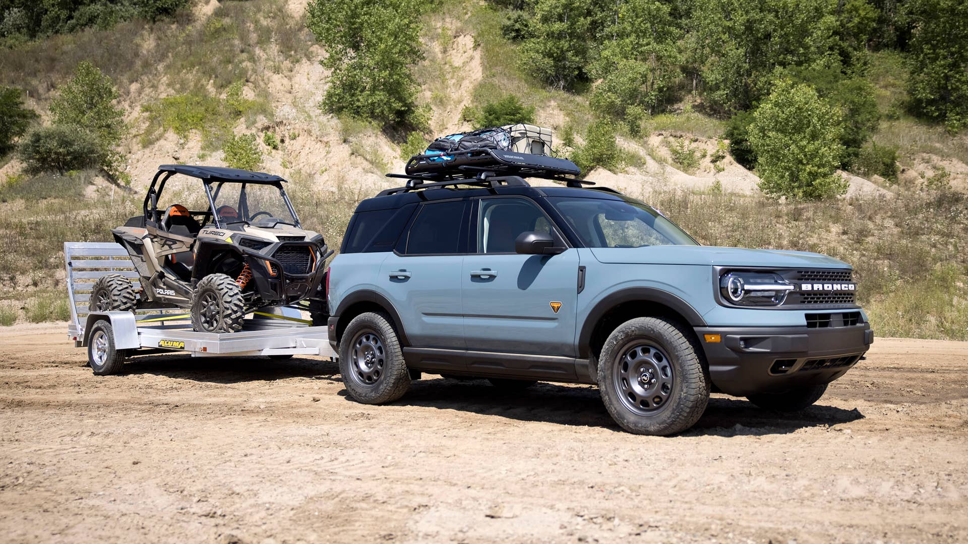 Bronco Sport TOW RZR. TOW RZR matches the added passenger comfort and technology features of the Badlands series with towing and cargo accessories to help adventurers haul more outdoor gear. The custom build adds Yakima HD Bar crossbars and OffGrid medium cargo basket and Class II Trailer Tow Package with 2,200 pounds of capacity to tow off-road runners like the all-new Polaris® RZR XP Turbo 1000™, unveiled today as part of the Bronco birthday celebration. (Preproduction image with optional features shown. Available late 2020.)