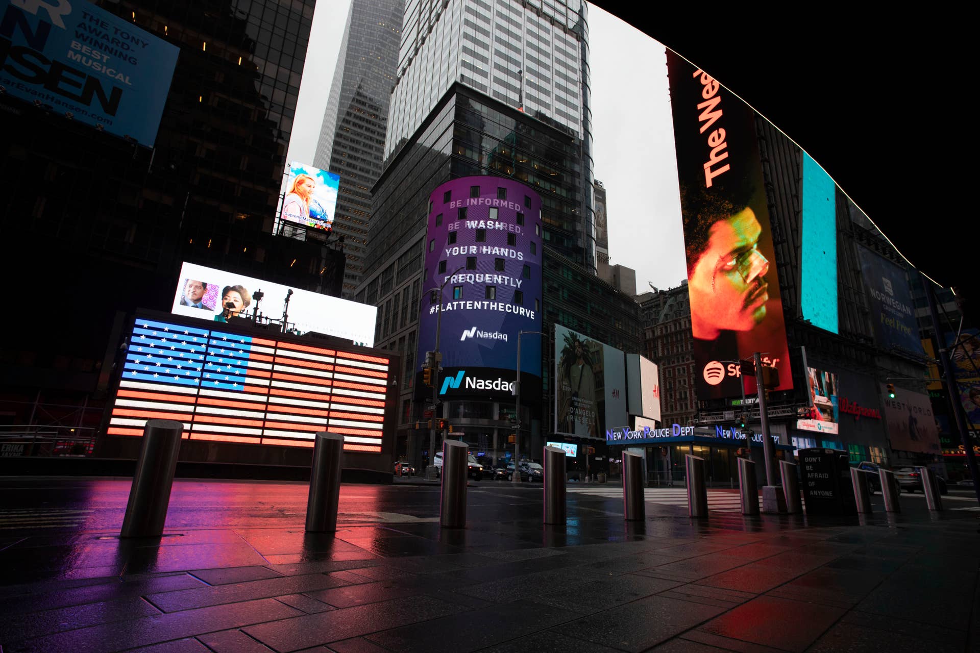 Times Square, which is usually very crowded on a weekday morning, is mostly empty Monday, March 23, 2020 in New York. Gov. Andrew Cuomo has ordered most New Yorkers to stay home from work to slow the coronavirus pandemic. (AP Photo/Mark Lennihan)