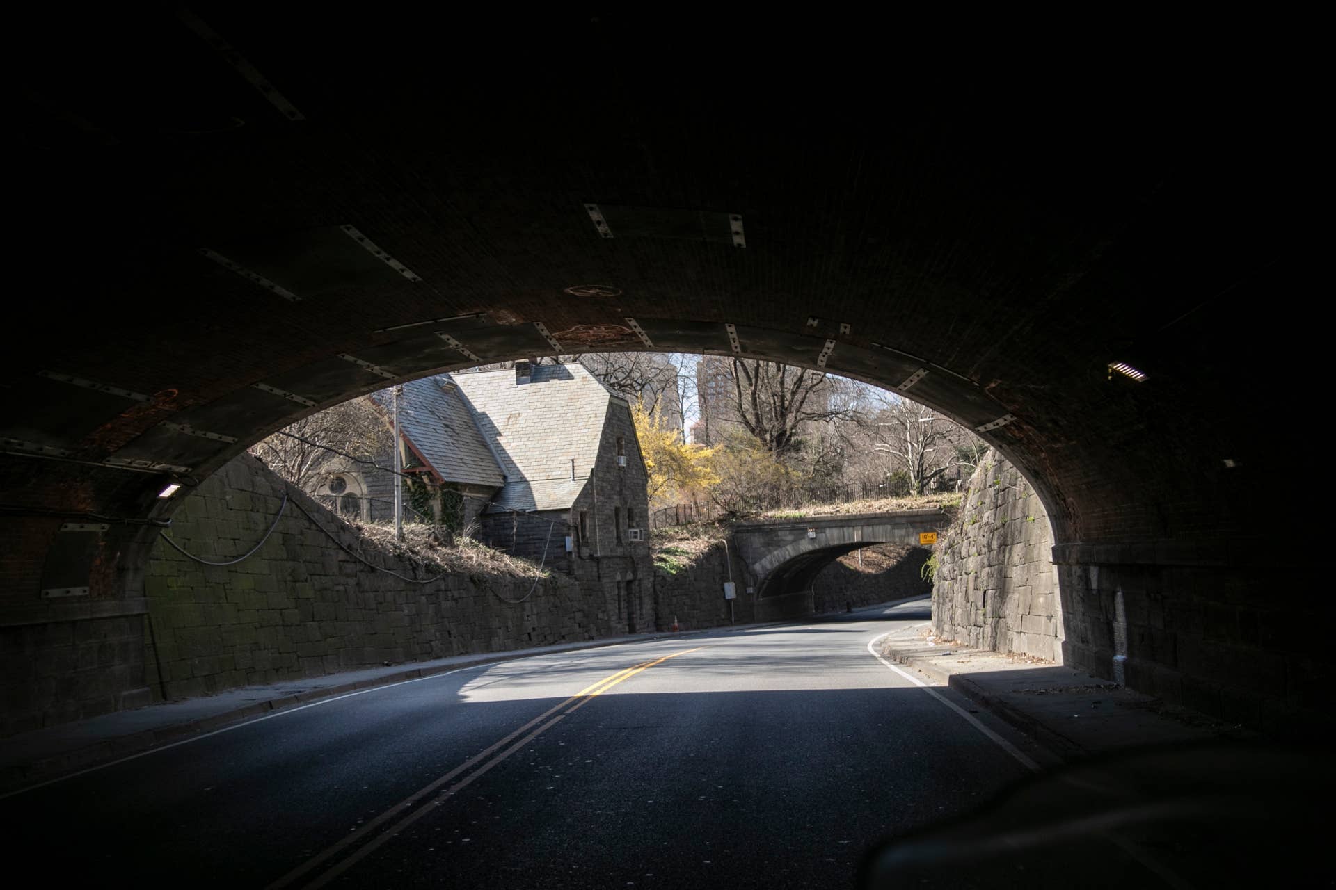 The road which runs through Central Park is free of traffic in New York, on Sunday, March 22, 2020. New York City's mayor prepared Sunday to order his city behind closed doors in an attempt to slow a pandemic that has swept across the globe and threatened to make the city of 8.5 million one of the world's biggest coronavirus hot spots. (AP Photo/Wong Maye-E)