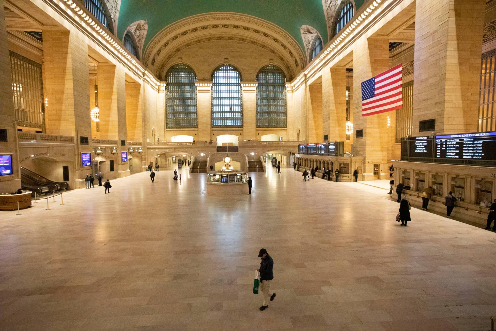 Commuters pass through Grand Central Terminal during the morning rush hour, Monday, March 23, 2020, in New York. Gov. Andrew Cuomo has ordered most New Yorkers to stay home from work to slow the coronavirus pandemic. (AP Photo/Mark Lennihan)