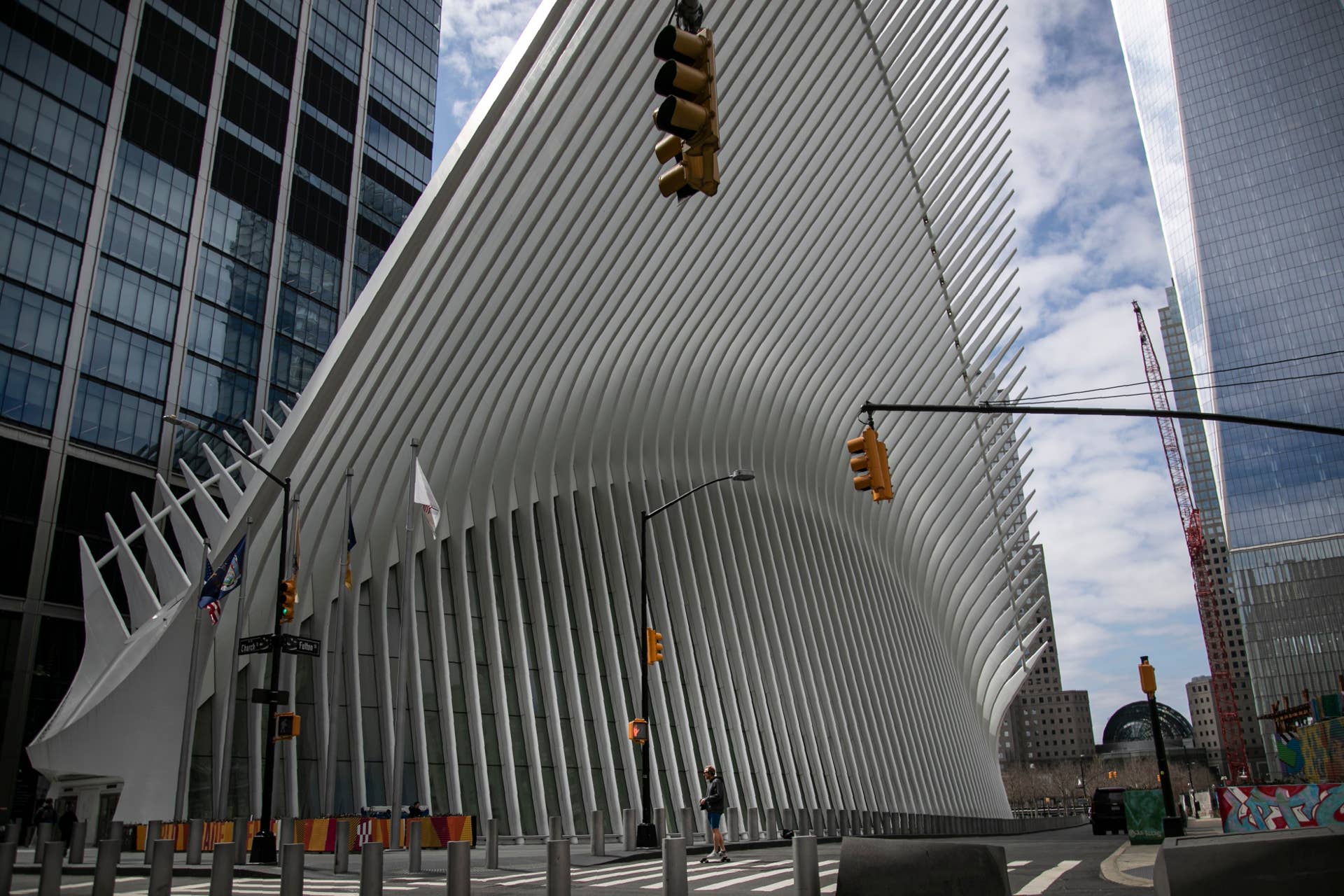 A man is dwarfed against the transportation hub and shopping mall known as the Oculus as he rides his skateboard in downtown Manhattan on Sunday, March 22, 2020, in downtown New York. New York City's mayor prepared Sunday to order his city behind closed doors in an attempt to slow a pandemic that has swept across the globe and threatened to make the city of 8.5 million one of the world's biggest coronavirus hot spots. (AP Photo/Wong Maye-E)