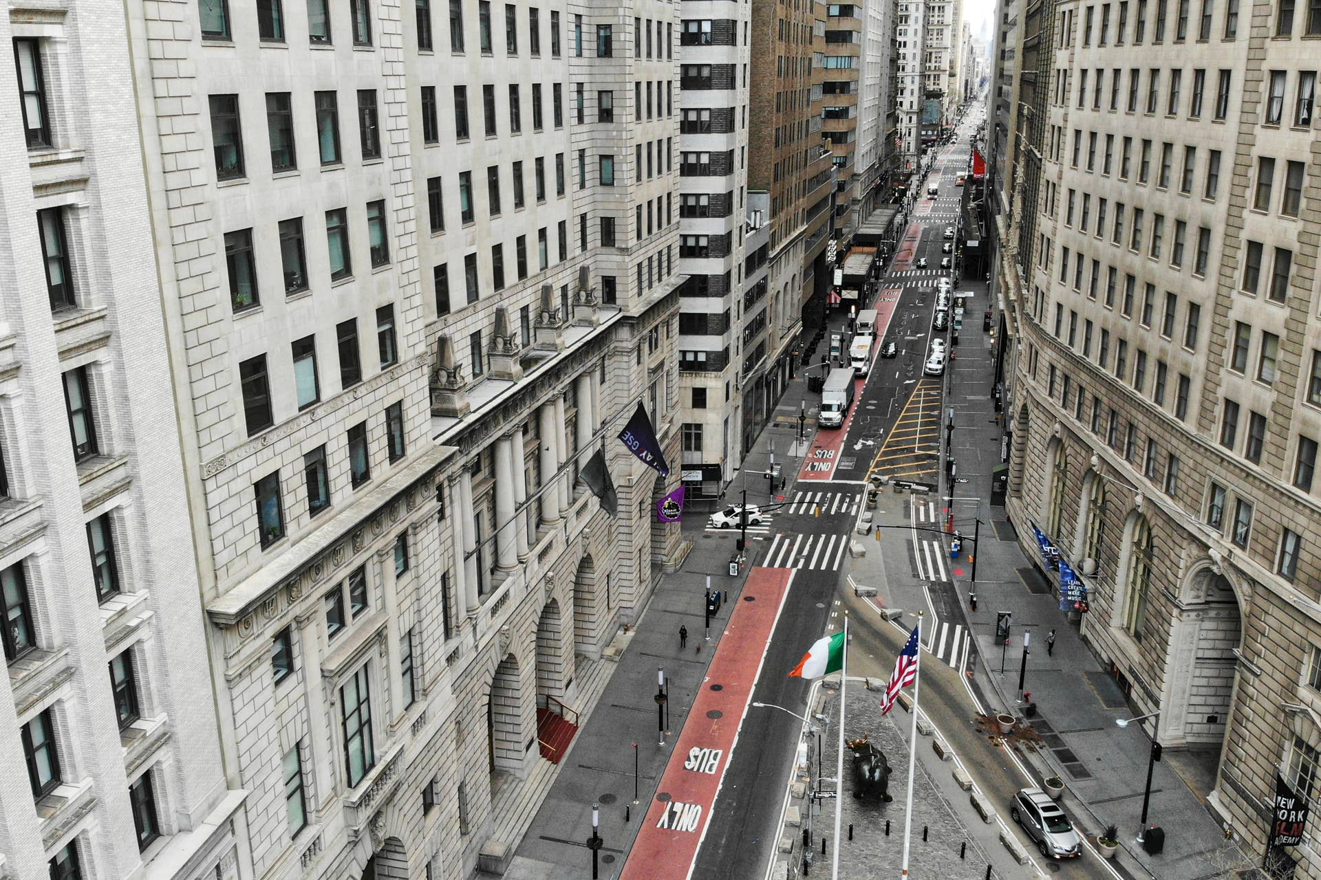 A lone pedestrian walks down Broadway as COVID-19 concerns empty a typically bustling downtown area, Saturday, March 21, 2020, in New York. New York Gov. Andrew Cuomo announced sweeping orders Friday that will severely restrict gatherings of any size for the state's more than 19 million residents and will require workers in nonessential businesses to stay home. (AP Photo/John Minchillo)