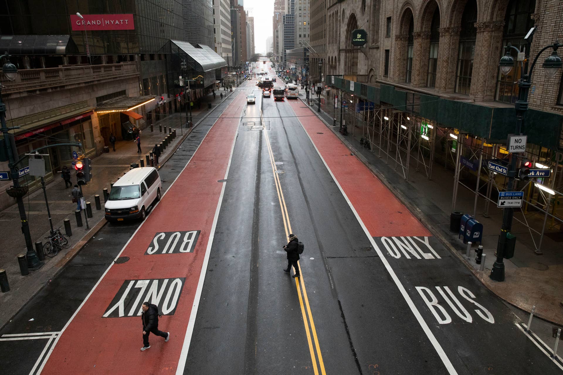Commuters cross 42nd Street in front of Grand Central Terminal during morning rush hour, Monday, March 23, 2020, in New York. Gov. Andrew Cuomo has ordered most New Yorkers to stay home from work to slow the coronavirus pandemic. (AP Photo/Mark Lennihan)
