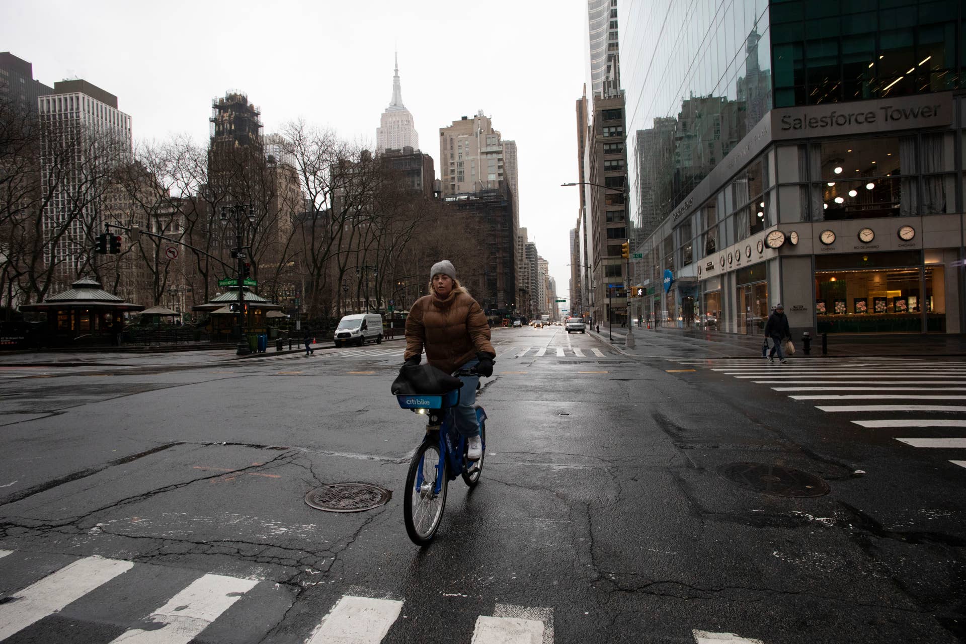 A woman cycles up Sixth Avenue, Monday, March 23, 2020 in New York. Gov. Andrew Cuomo has ordered most New Yorkers to stay home from work to slow the coronavirus pandemic. (AP Photo/Mark Lennihan)