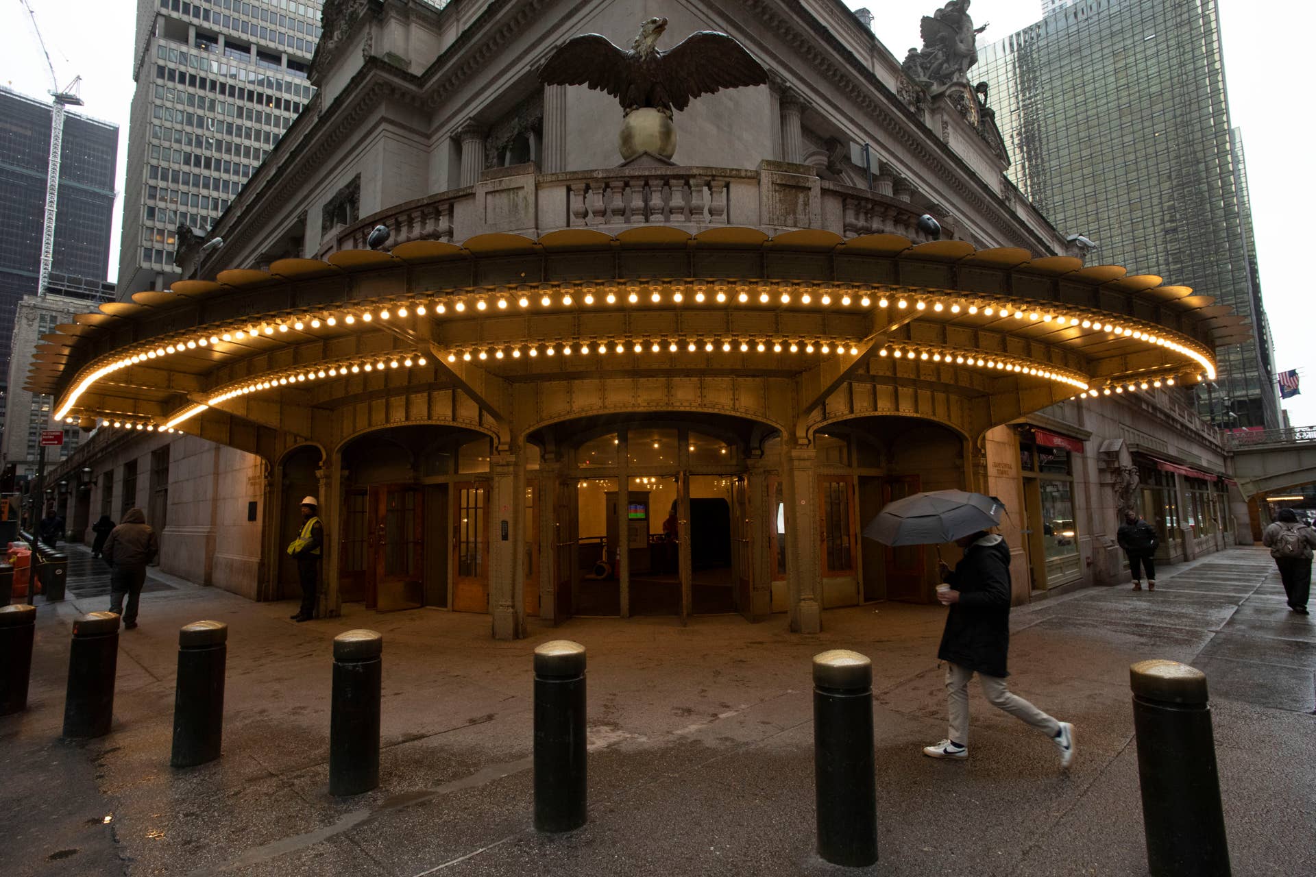 A commuter walks by the entrance to Grand Central Terminal, Monday, March 23, 2020 in New York. Gov. Andrew Cuomo has ordered most New Yorkers to stay home from work to slow the coronavirus pandemic. (AP Photo/Mark Lennihan)