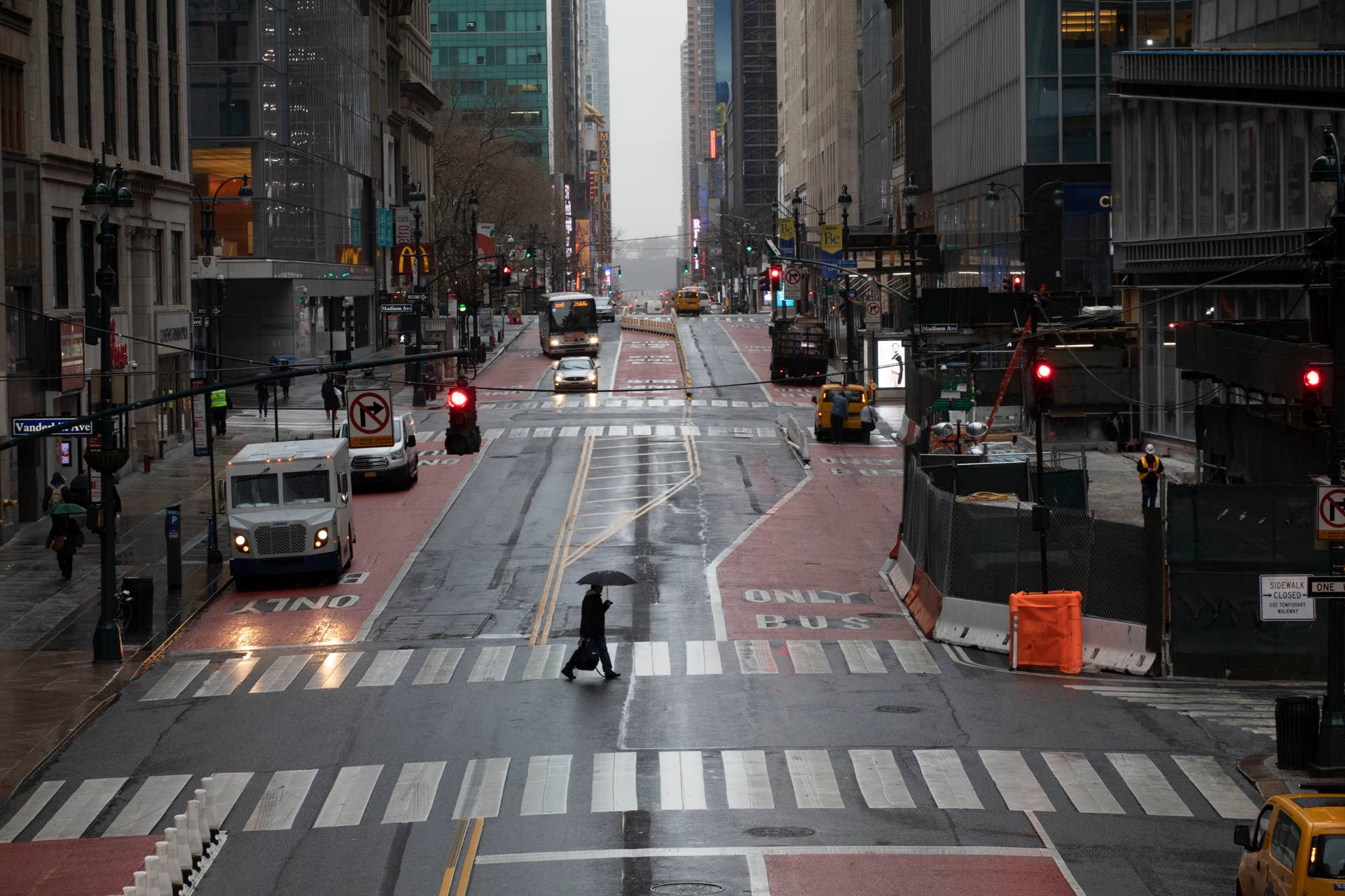 A commuter crosses 42nd Street in front of Grand Central Terminal during morning rush hour, Monday, March 23, 2020, in New York. Gov. Andrew Cuomo has ordered most New Yorkers to stay home from work to slow the coronavirus pandemic. (AP Photo/Mark Lennihan)
