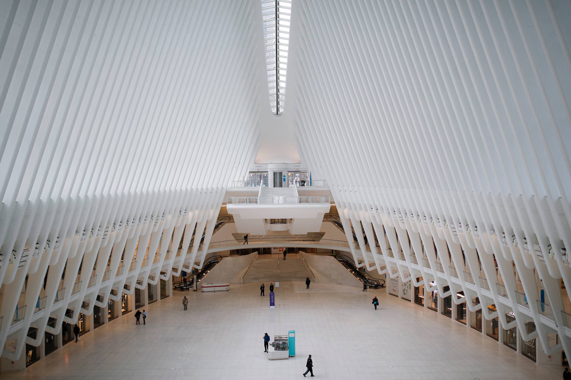 A security guard walks through a sparsely populated transit hub in the downtown financial district as retail stores remain shuttered due to COVID-19 concerns, Saturday, March 21, 2020, in New York. As of Sunday, nearly 2,000 people with the virus have been hospitalized in the state of New York and 114 have died, officials said. More than 15,000 have tested positive statewide, including 9,000 in New York City. (AP Photo/John Minchillo)