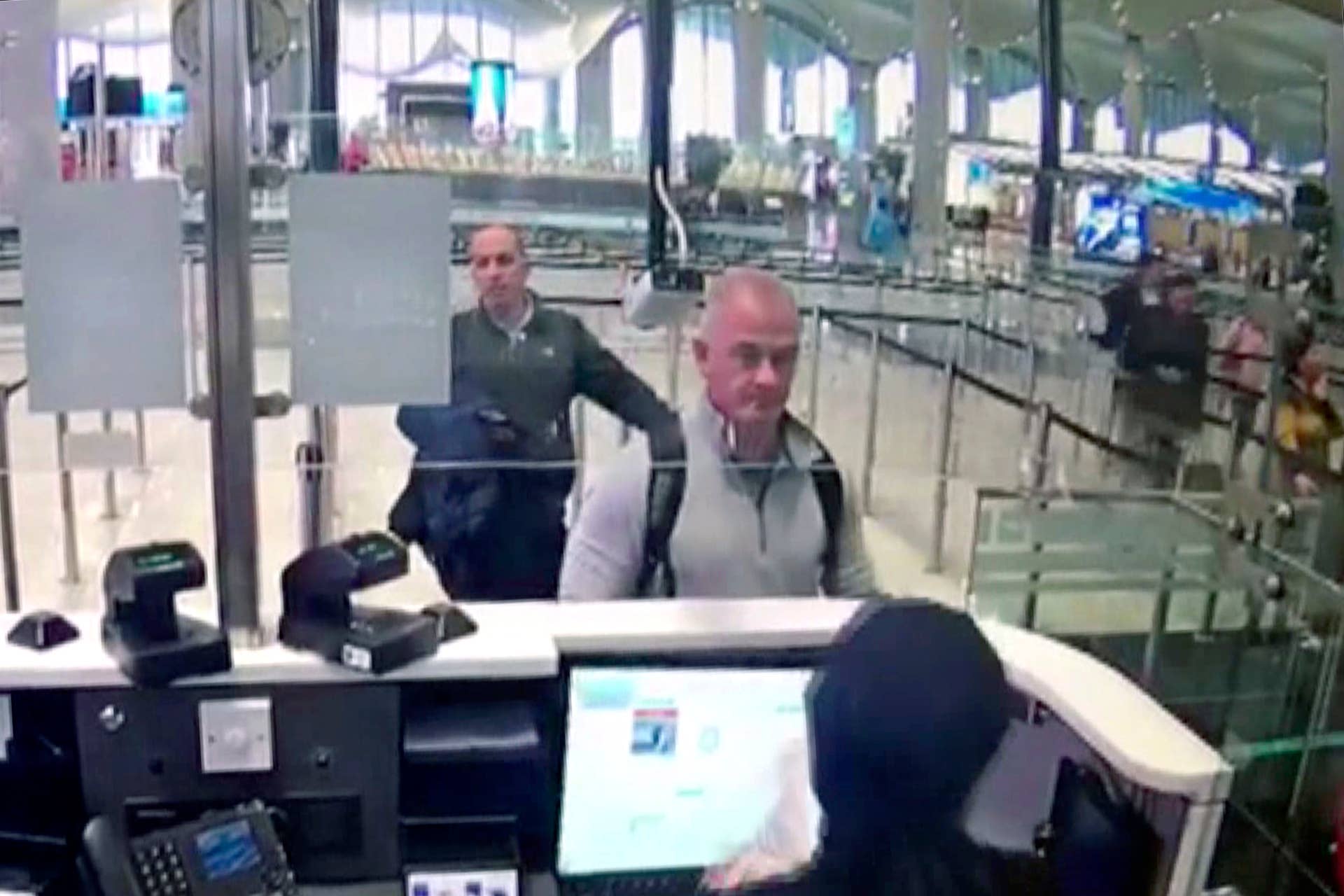 FILE - This Dec. 30, 2019 image from security camera video shows Michael L. Taylor, center, and George-Antoine Zayek at passport control at Istanbul Airport in Turkey. The U.S. State Department has agreed to turn over to Japan Taylor and his son Peter Taylor, who are accused of smuggling former Nissan Motor Co. Chairman Carlos Ghosn out of the country while he was awaiting trial, the men's lawyers said in legal filing on Thursday, Oct. 29, 2020. (DHA via AP)