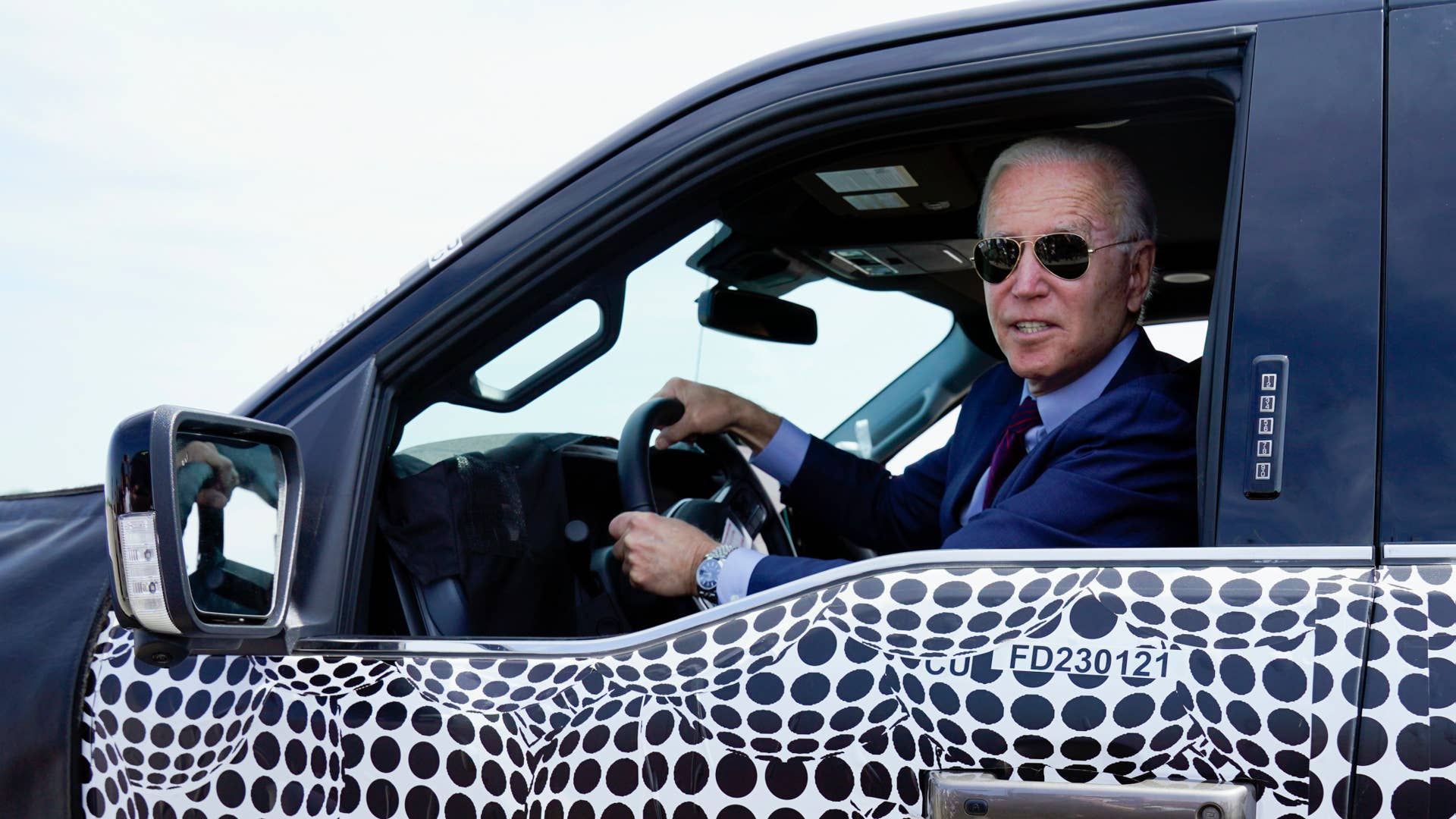 President Joe Biden stops to talk to the media as he drives a Ford F-150 Lightning truck at Ford Dearborn Development Center, Tuesday, May 18, 2021, in Dearborn, Mich. (AP Photo/Evan Vucci)