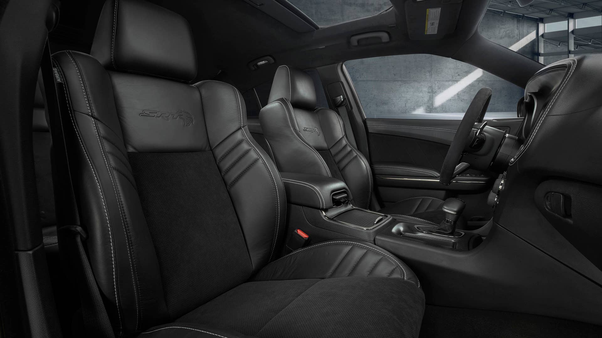 The race-inspired interior of the Dodge Charger SRT Hellcat Widebody features standard heated and ventilated Laguna leather front seats with embossed Hellcat logo - available interior color combinations include Black, Black/Sepia or Black/Demonic Red