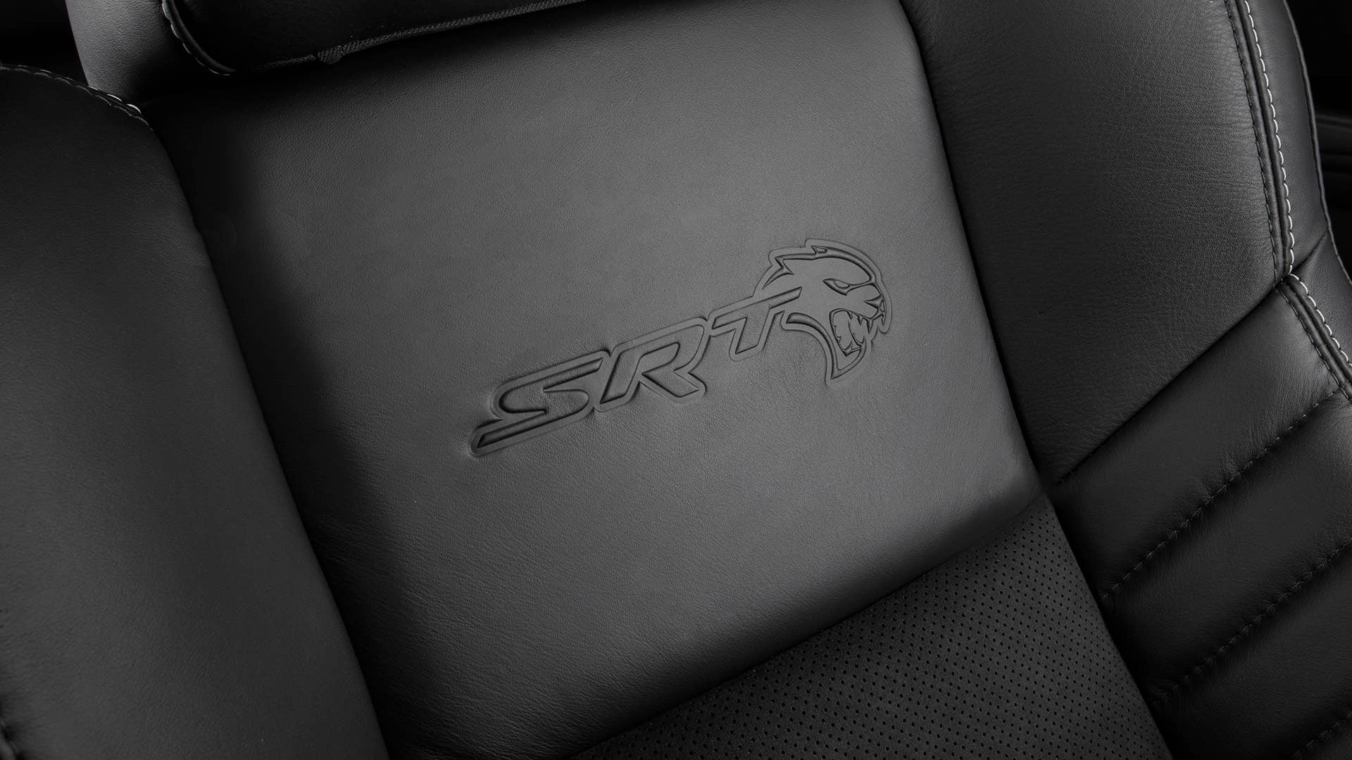Standard heated and ventilated Laguna leather front seats feature embossed Hellcat logo in the 2020 Dodge Charger SRT Hellcat Widebody