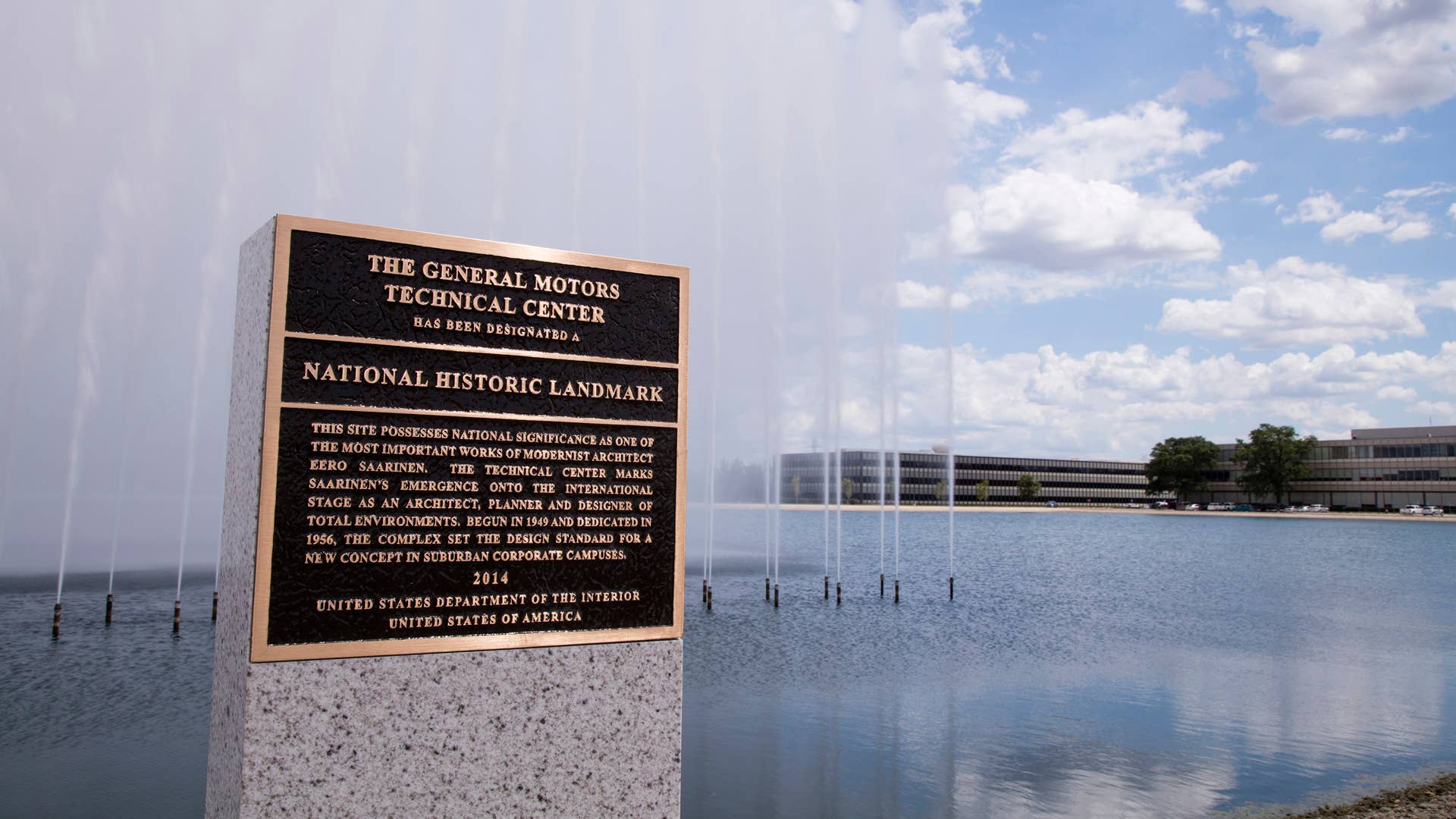 General Motors revealed the newly installed and dedicated National Historic Landmark bestowed upon the GM Technical Center located in Warren, Mi, on Aug. 6, 2015 The National Park Service selected the campus for this honor because it possesses national significance as one of the most important works of modernist architect Eero Saarinen. When the GM Tech Center was dedicated in 1956, it was the pinnacle of engineering, design and advance technology, and marked Saarinen’s emergence onto the international stage as an architect, planner and designer of total environments. Directly behind the landmark is the Wall of Water Fountain, which pumps 6,000 gallons of water per minute to create a 115-foot wide, 55-foot high “wall of water.” And, the GM Design Center borders the lake on the south end of the footprint, shown to the far right.