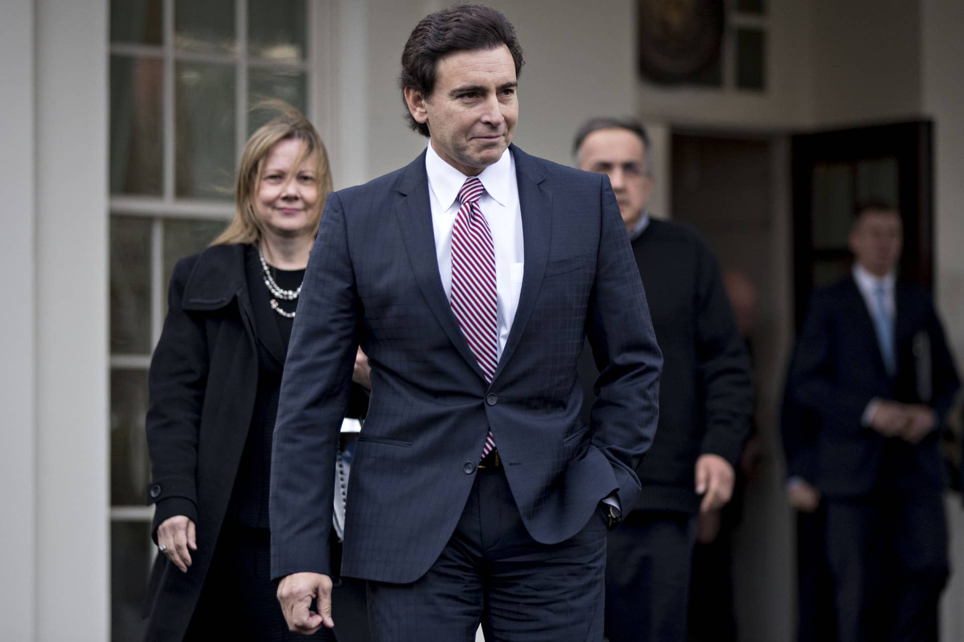 Mark Fields, president and chief executive officer of Ford Motor Co., center, Mary Barra, chief executive officer of General Motors Co. (GM), left, and Sergio Marchionne, chief executive officer of Fiat Chrysler Automobiles NV, arrive to a news conference outside the White House after a meeting with U.S. President Donald Trump, not pictured, in Washington, D.C., U.S., on Tuesday, Jan. 24, 2017. Trump told chief executives of the three biggest U.S. automakers that environmental regulations are out of control and promised he would remove obstacles for manufacturers and oil companies. Photographer: Andrew Harrer/Bloomberg via Getty Images