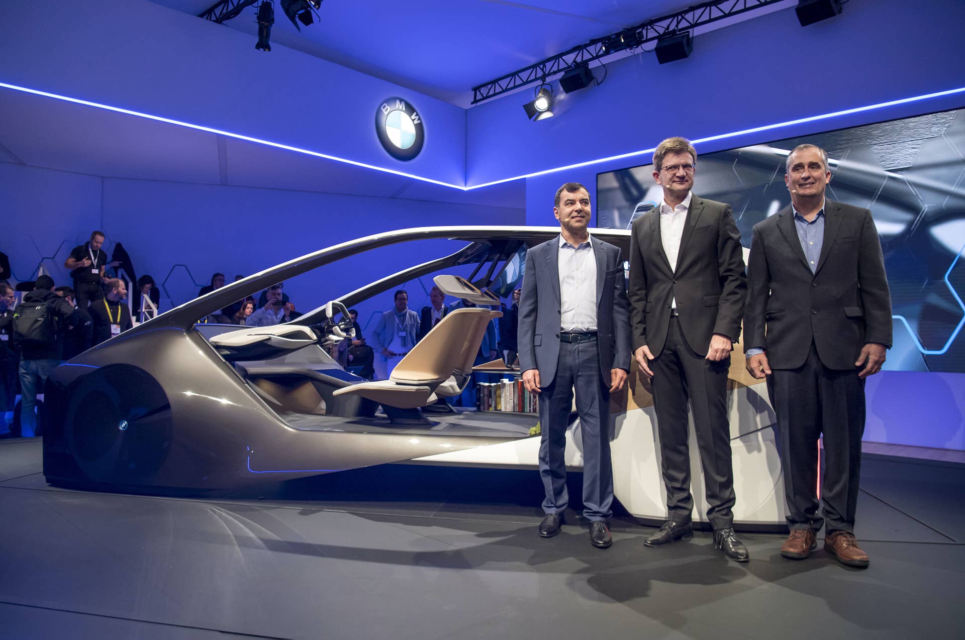 Amnon Shahua, chairman and chief technology officer of Mobileye, from left, Klaus Froehlich, member of the management board at Bayerische Motoren Werke AG (BMW), and Brian Krzanich, chief executive officer of Intel Corp., stand for a photograph in front of the BMWi Inside Future concept vehicle during a press event at the 2017 Consumer Electronics Show (CES) in Las Vegas, Nevada, U.S., on Wednesday, Jan. 4, 2017. BMW AG will dispatch a fleet of autonomous vehicles to U.S. and European cities in this year's second half, the next step in its partnership with Mobileye NV and Intel Corp. to introduce fully self-driving vehicles by 2021. Photographer: David Paul Morris/Bloomberg via Getty Images