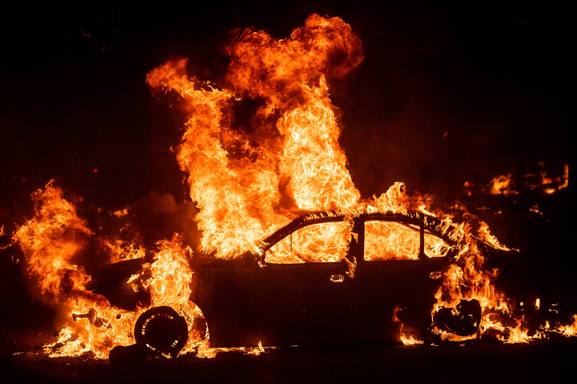 Flames from the Kincade Fire consume a car in the Jimtown community of unincorporated Sonoma County, Calif., on Thursday, Oct. 24, 2019. (AP Photo/Noah Berger)
