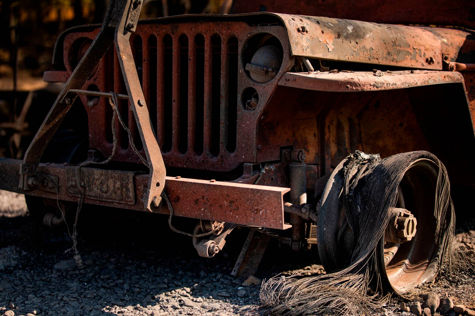The charred remains of a vehicle sits on a property burned during the Kincade Fire, along Highway 128 at  in Healdsburg, California on October 28, 2019. - California's governor declared a state-wide emergency on October 27 as a huge wind-fueled blaze forced evacuations and massive power blackouts, threatening towns in the famed Sonoma wine region. (Photo by Philip Pacheco / AFP) (Photo by PHILIP PACHECO/AFP via Getty Images)