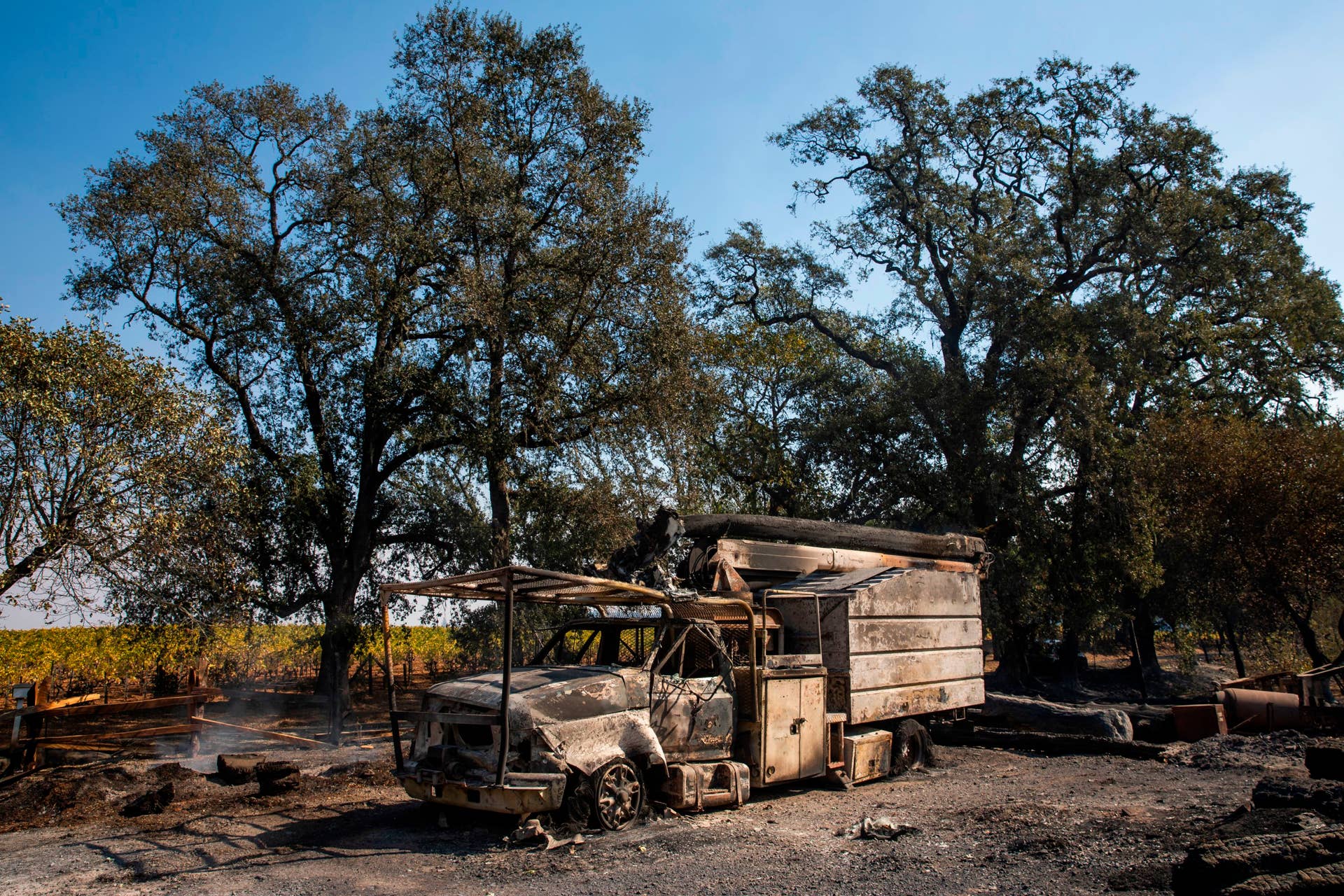 The smoldering remains of a utility truck sits on a property burned during the Kincade Fire, along Highway 128, in Healdsburg, California on October 28, 2019. - California's governor declared a state-wide emergency on October 27 as a huge wind-fueled blaze forced evacuations and massive power blackouts, threatening towns in the famed Sonoma wine region. (Photo by Philip Pacheco / AFP) (Photo by PHILIP PACHECO/AFP via Getty Images)