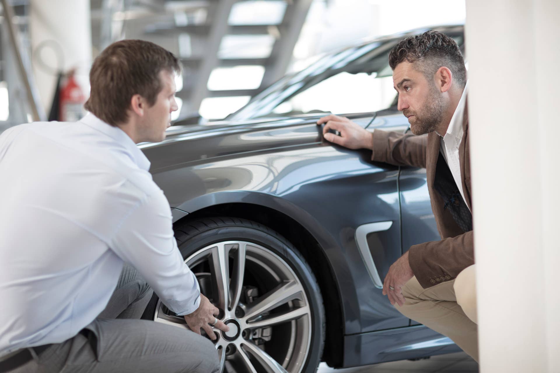 Cape Town, South Africa,salesman talking with customer in car dealership